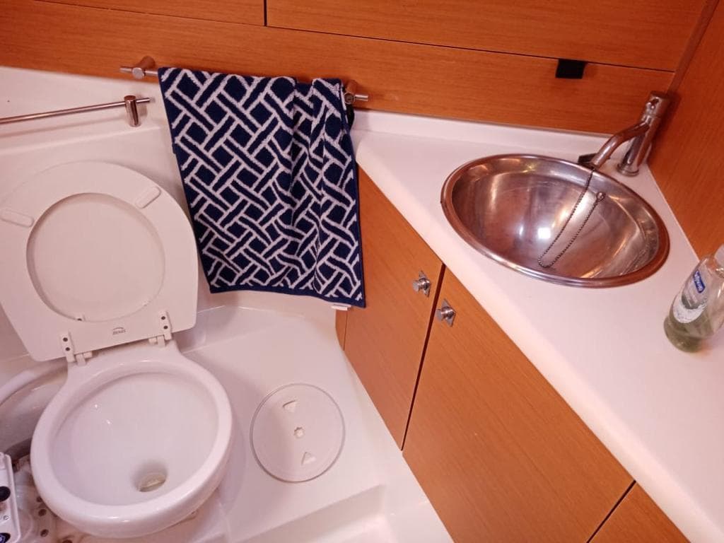 Bathroom interior of 2011 Jeanneau Sun Odyssey 45 yacht with sink and toilet.
