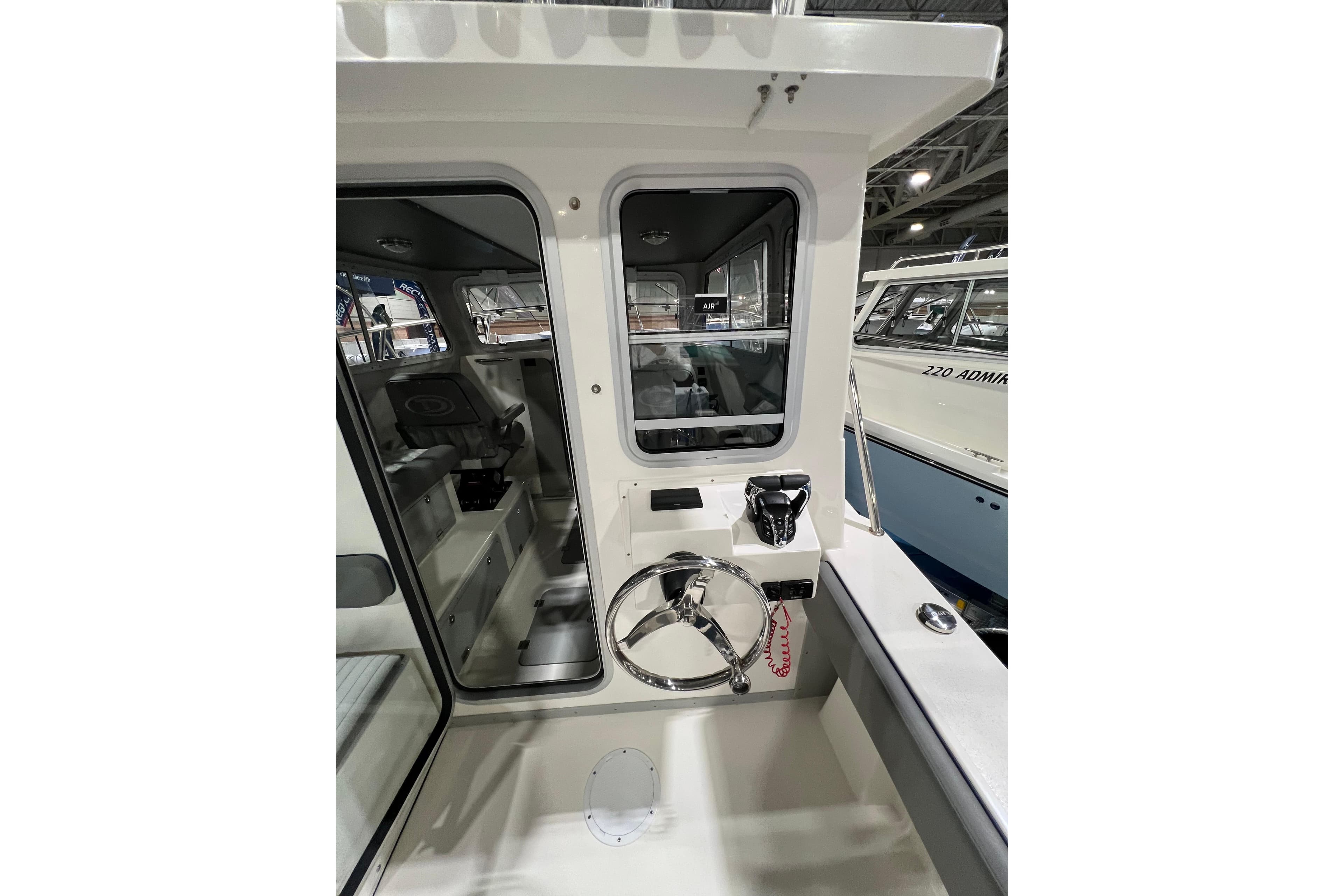 2025 Defiance 260 Admiral boat interior with steering wheel and control panel.