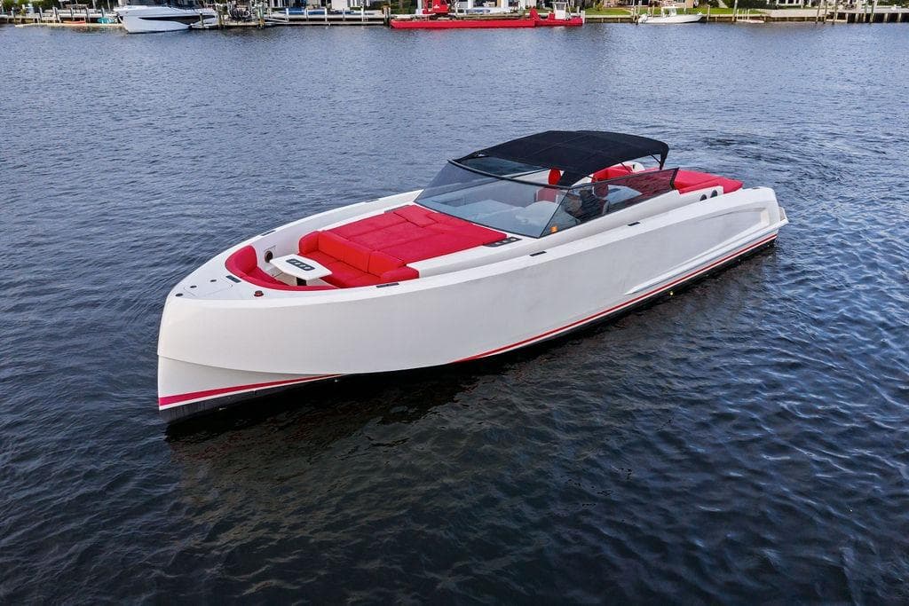 2016 Vanquish Yachts VQ48 luxury yacht with sleek design and red seating on the water.