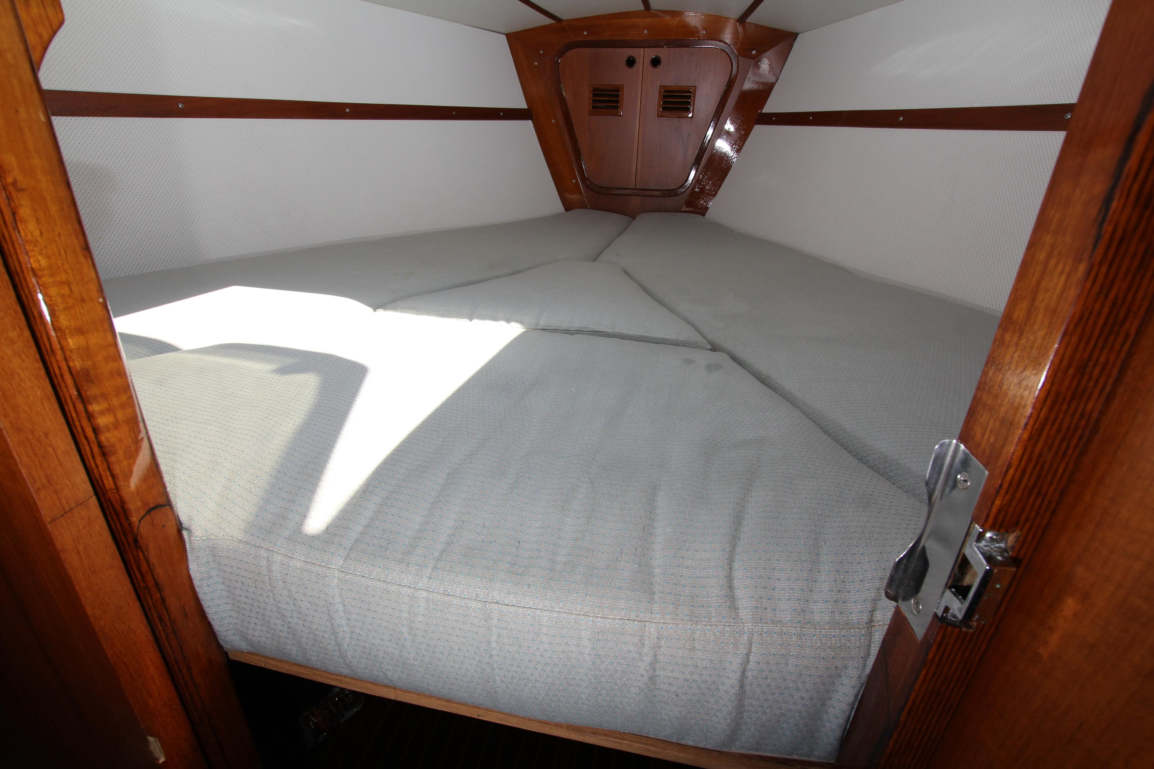 Cozy cabin interior of 1974 Nautor Swan 38 sailboat with comfortable bedding.