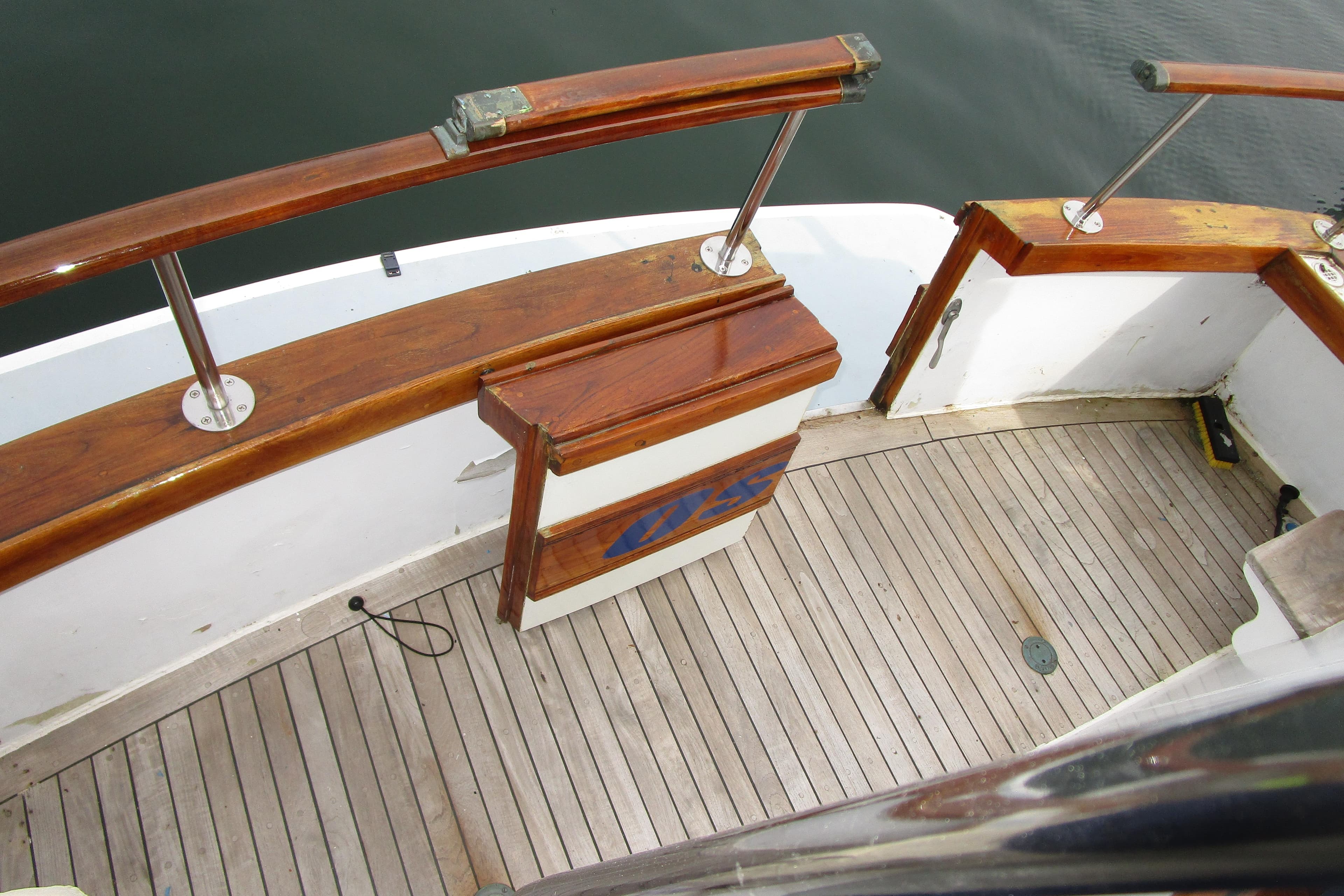 1979 Roughwater 41 boat deck with wooden railings and flooring.