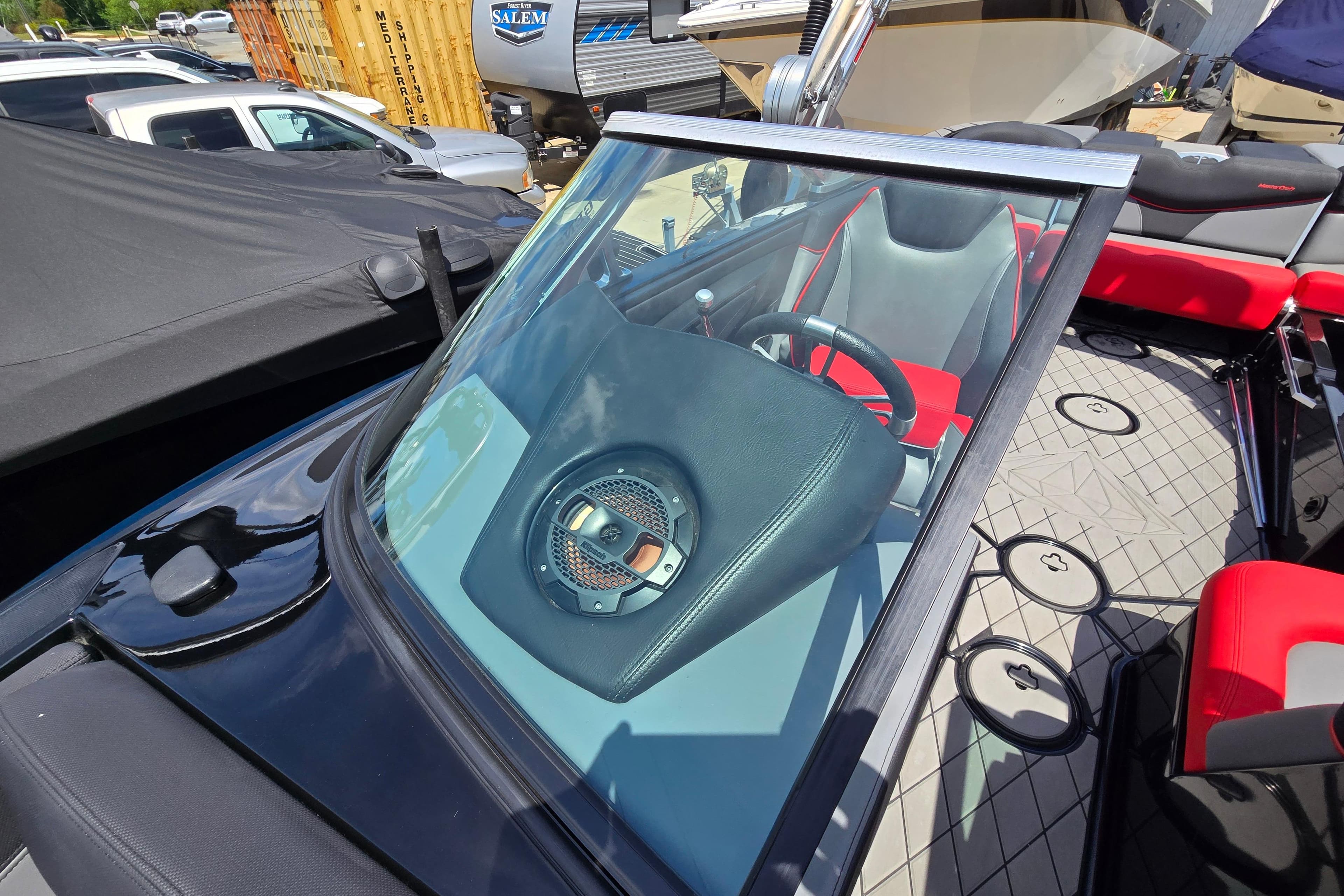 2019 MasterCraft XT25 boat interior with red and gray seating, visible steering wheel.
