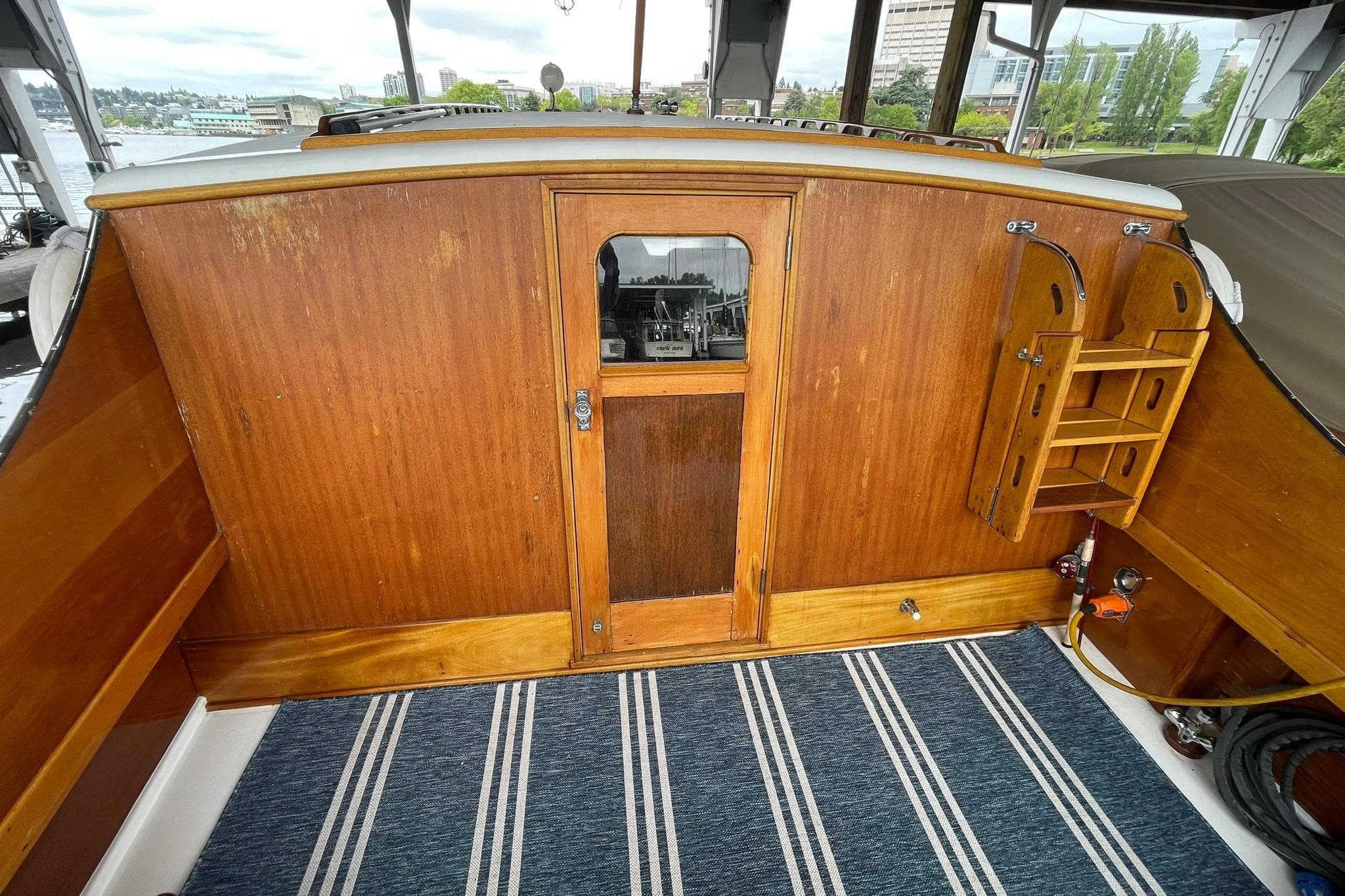 Interior of a 1948 Grandy 34 boat with wooden paneling and striped carpet.