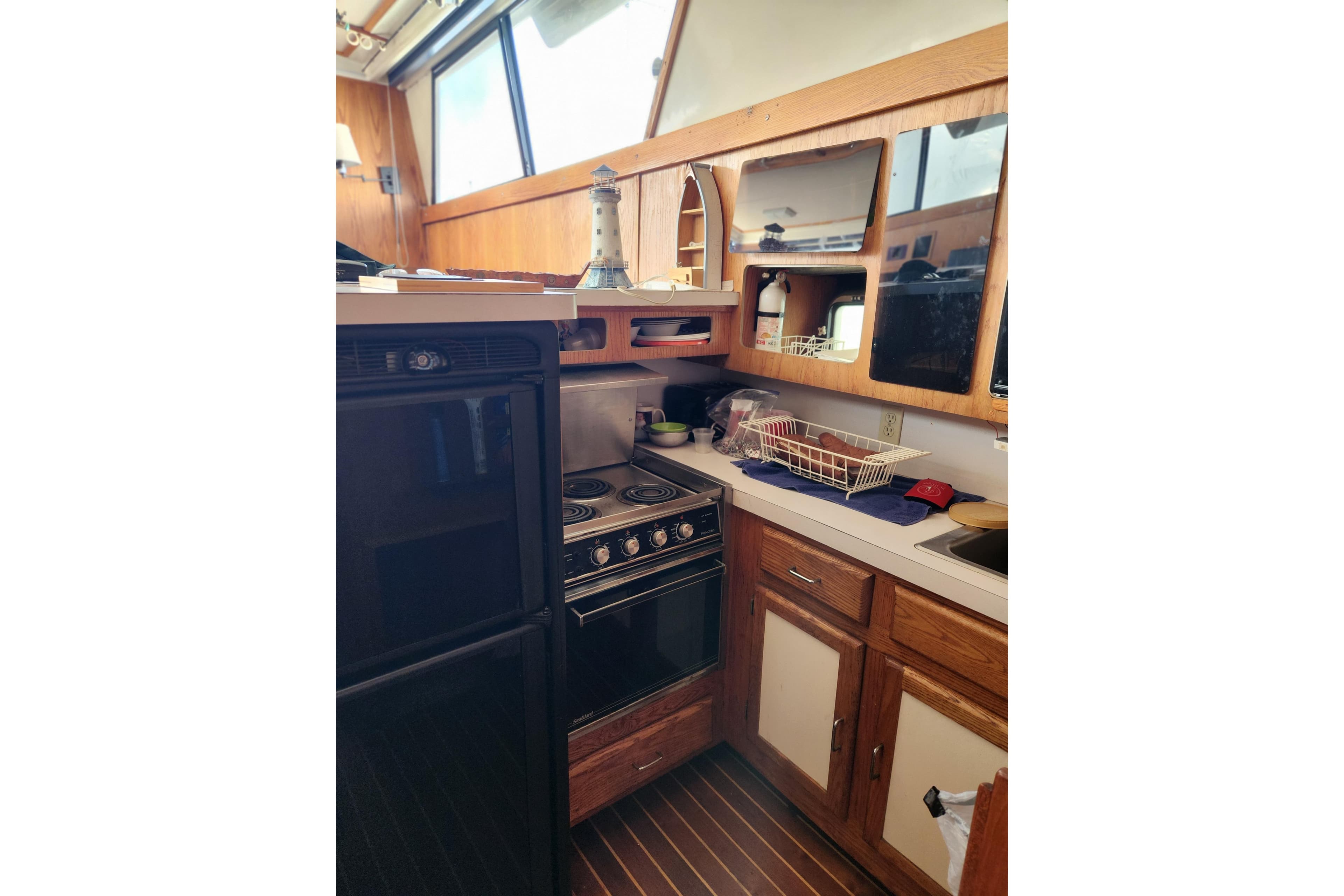 1987 Luhrs 40 Convertible yacht kitchen with stove, cabinets, and countertop.