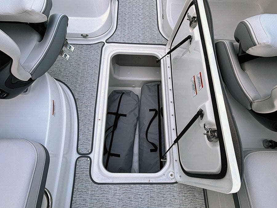 2025 Sea Ray SLX 260 Outboard boat storage compartment with open hatch and interior view.