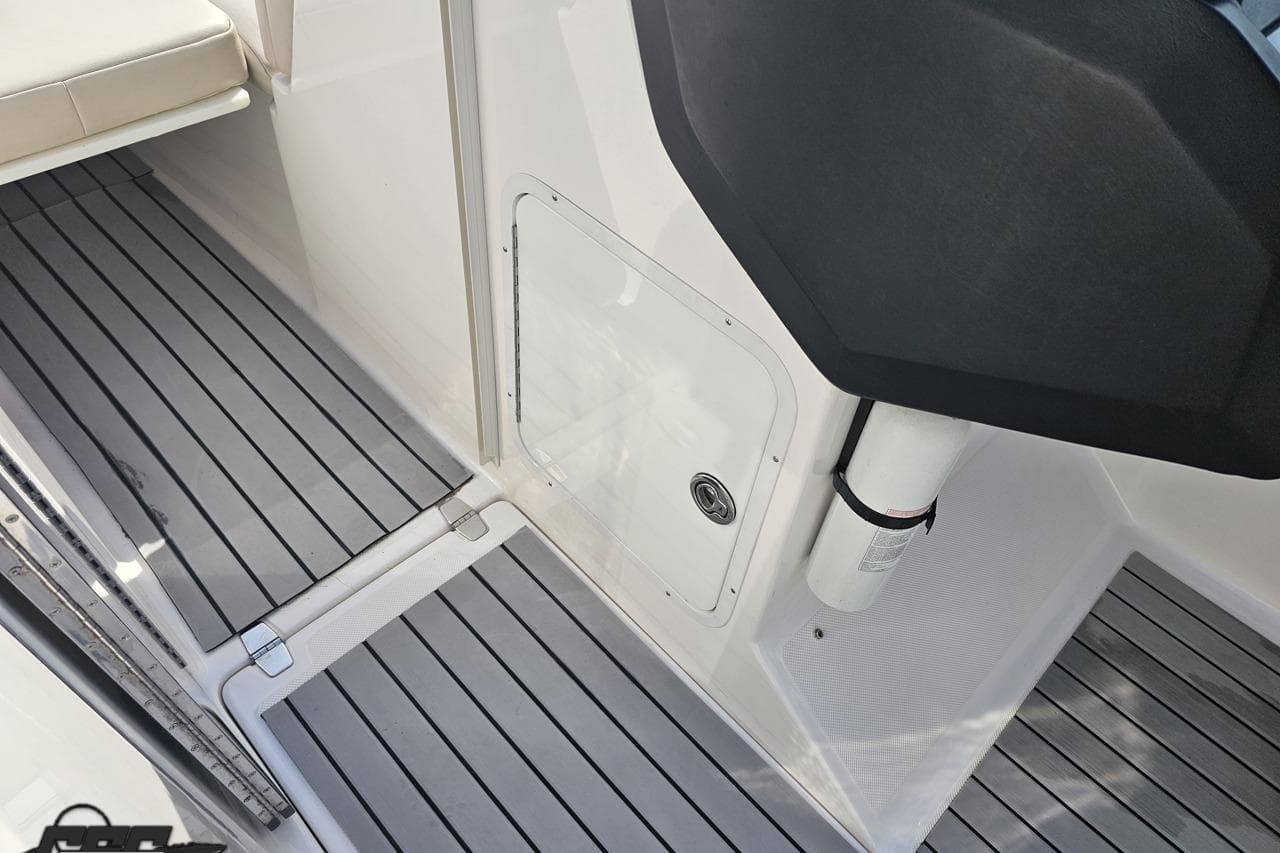 2008 Regal 2520 FasDeck boat interior with gray striped flooring and storage compartment.