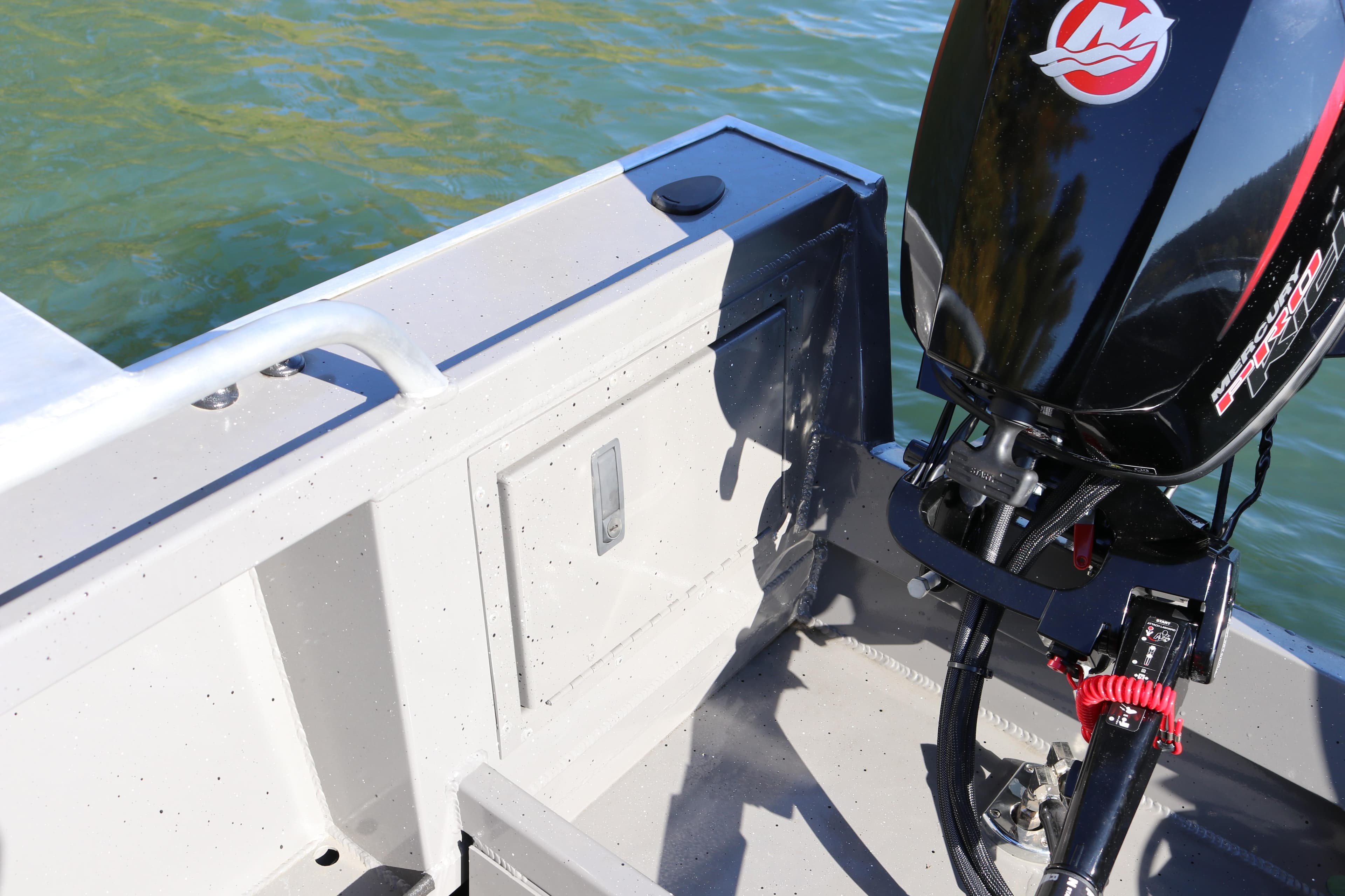 2026 Alumaweld Stryker 220 boat with outboard motor on a sunny day.
