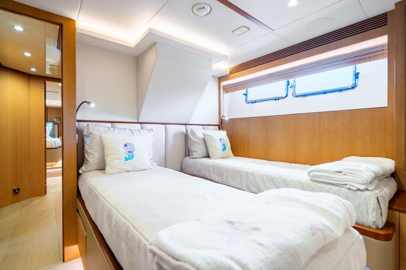 Luxurious twin cabin on 2020 Horizon FD80 yacht with modern decor and natural light.
