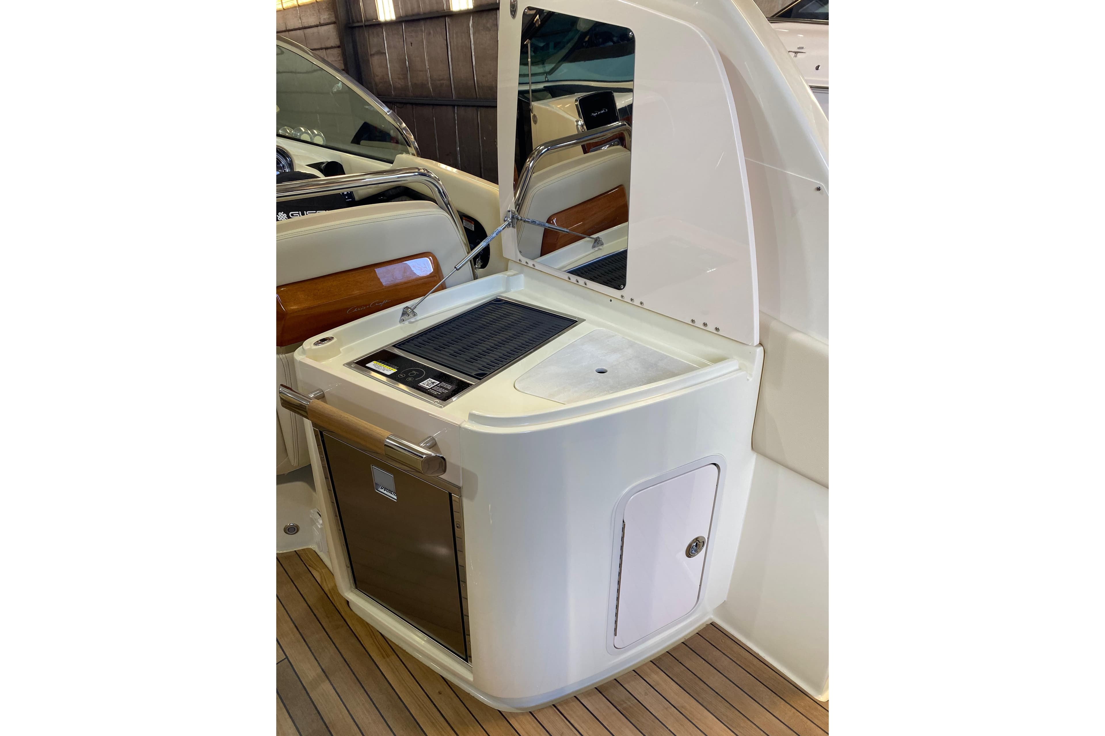 2026 Chris-Craft Launch 31 GT boat interior with kitchenette and wooden accents.