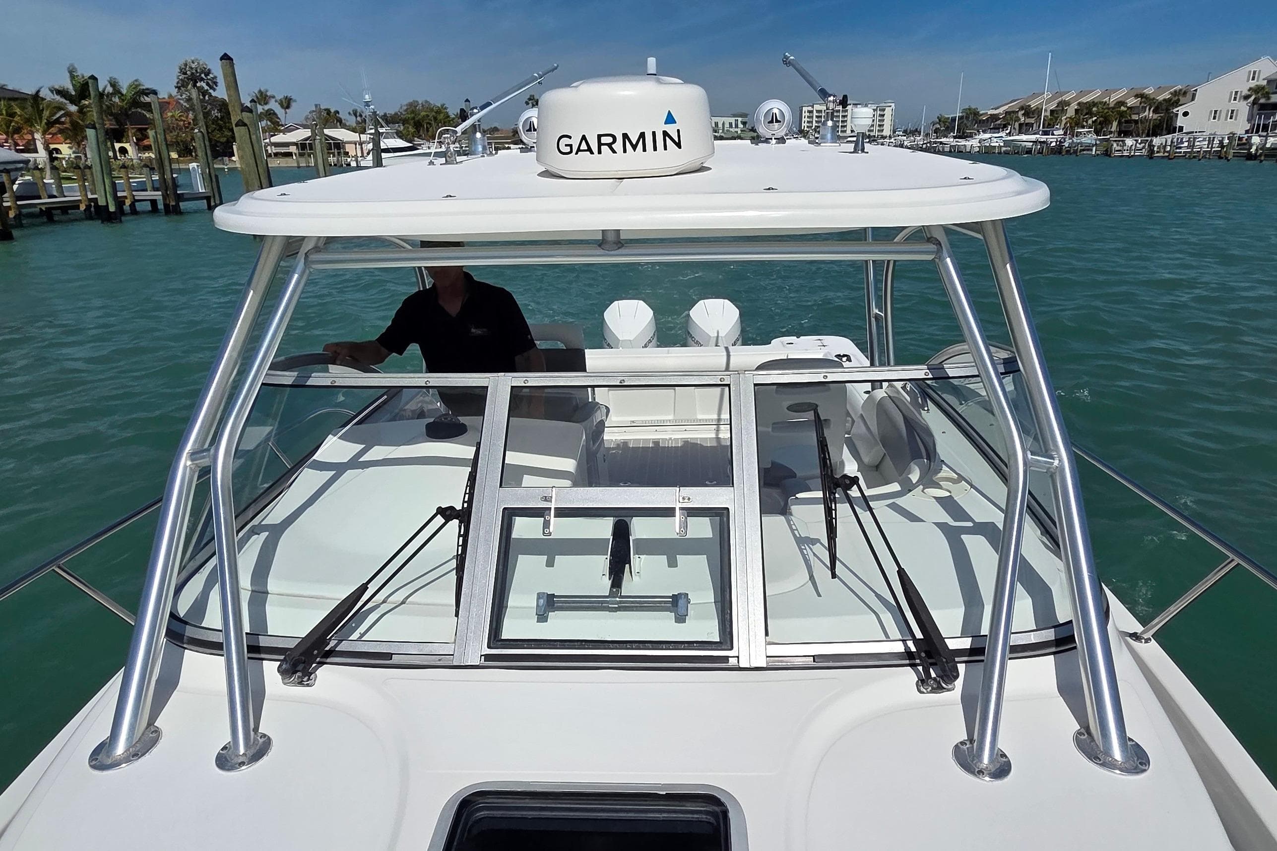 2007 Boston Whaler 305 Conquest boat with Garmin equipment on turquoise water.