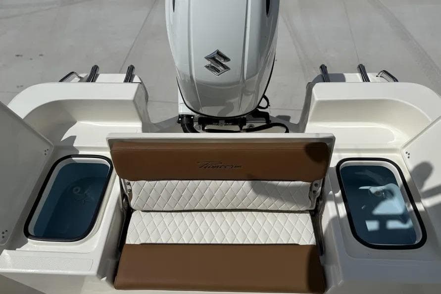 2026 Pioneer 220 Bay Sport boat with Suzuki engine and cushioned seating.