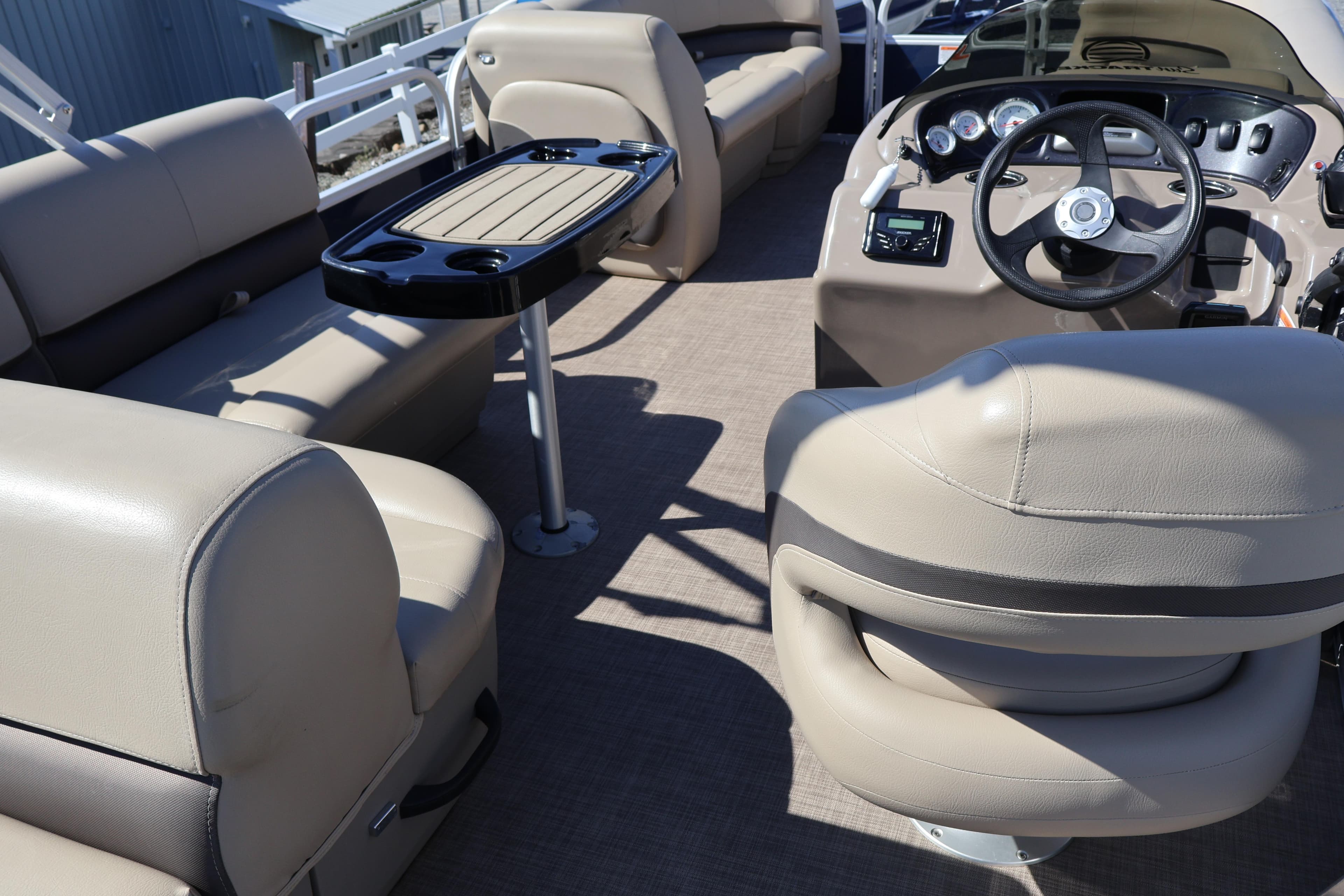 Interior of 2022 Sun Tracker Party Barge 18 DLX with seating and steering console.