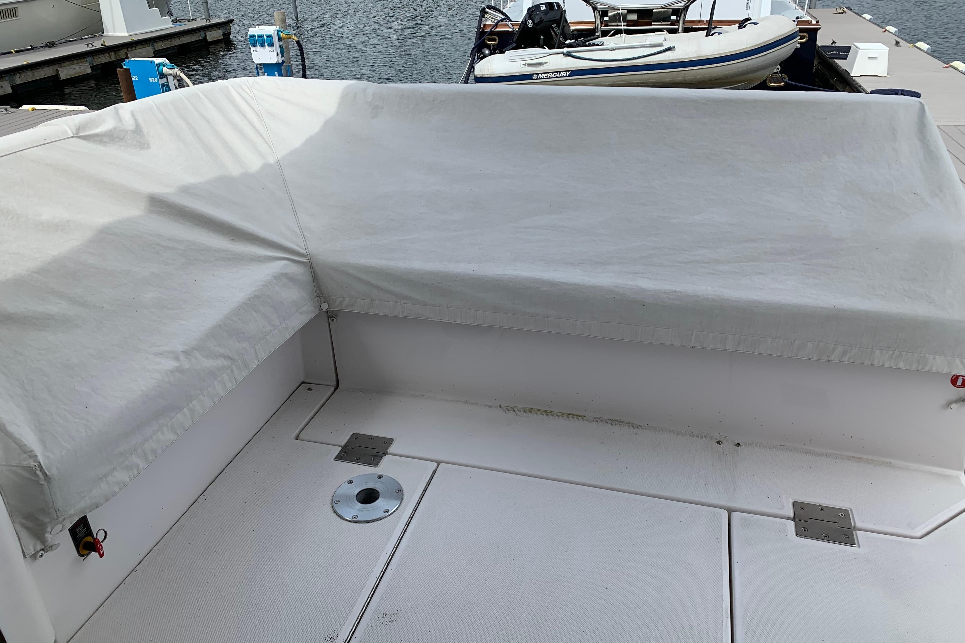 Covered seating area on a 2019 Regal 42 Grande Coupe yacht at a dock.