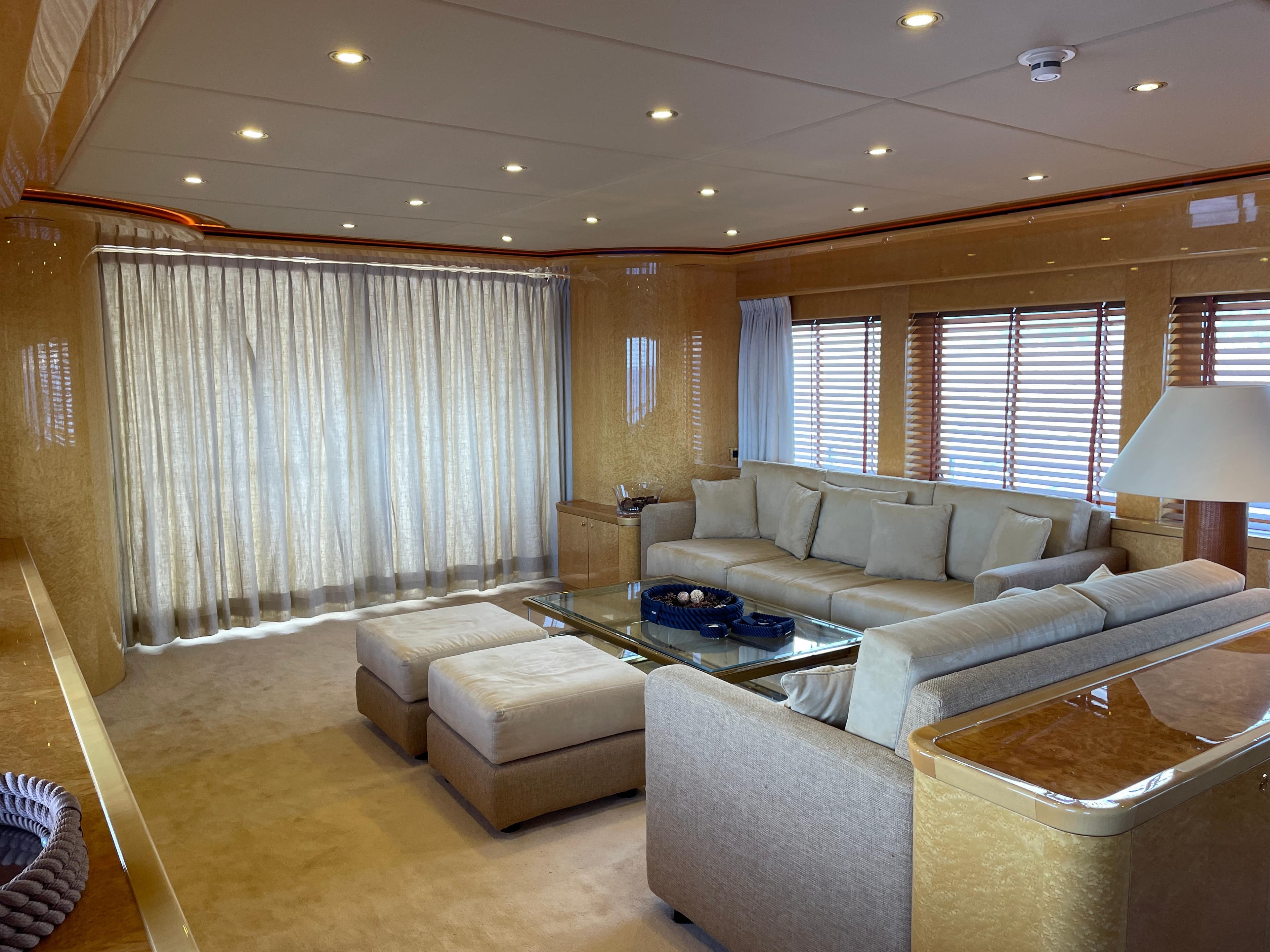 Luxurious interior of 2000 Heesen Versilcraft yacht with elegant seating and modern decor.
