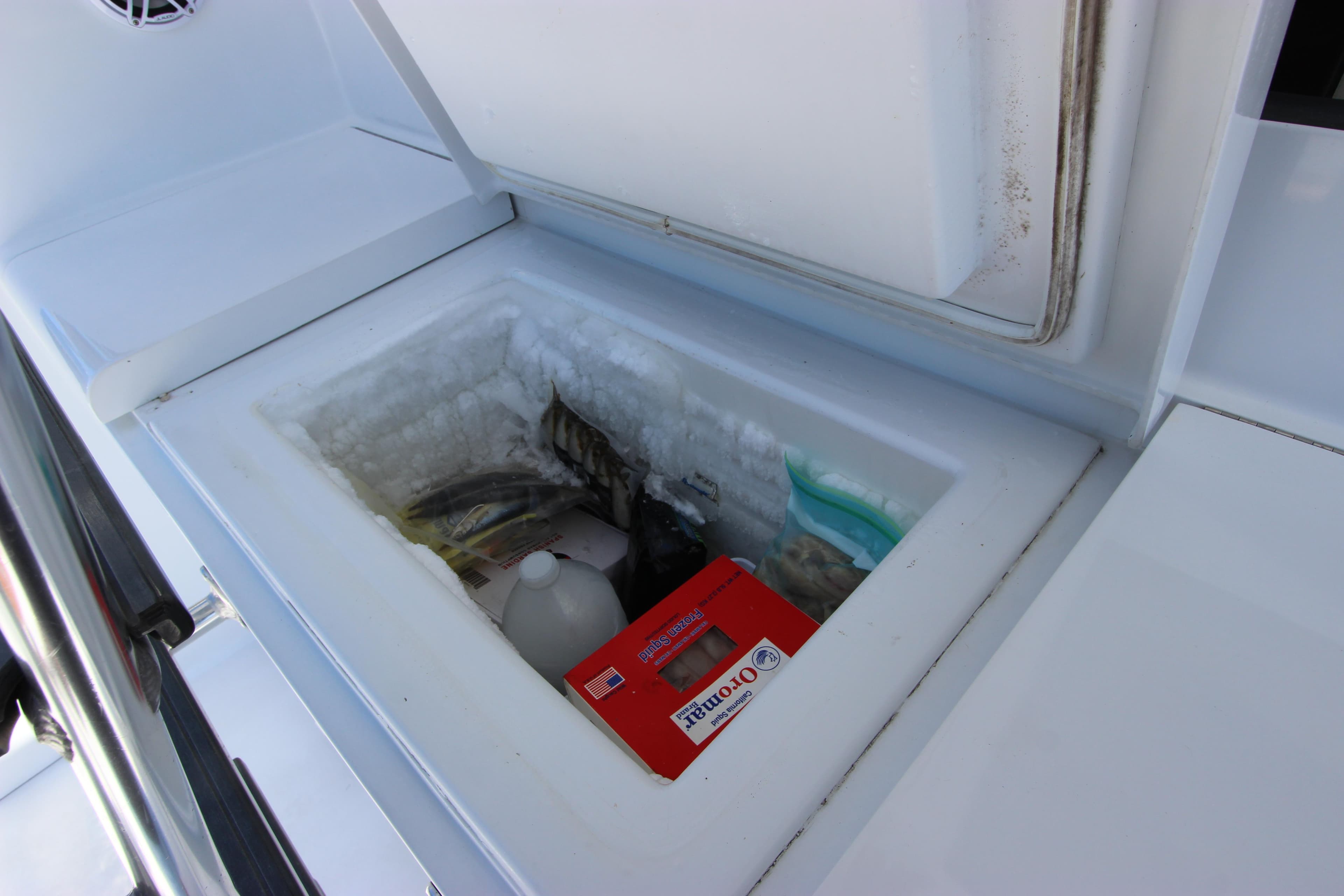 Built-in cooler on 2004 Hatteras 60 Convertible yacht, storing various items.