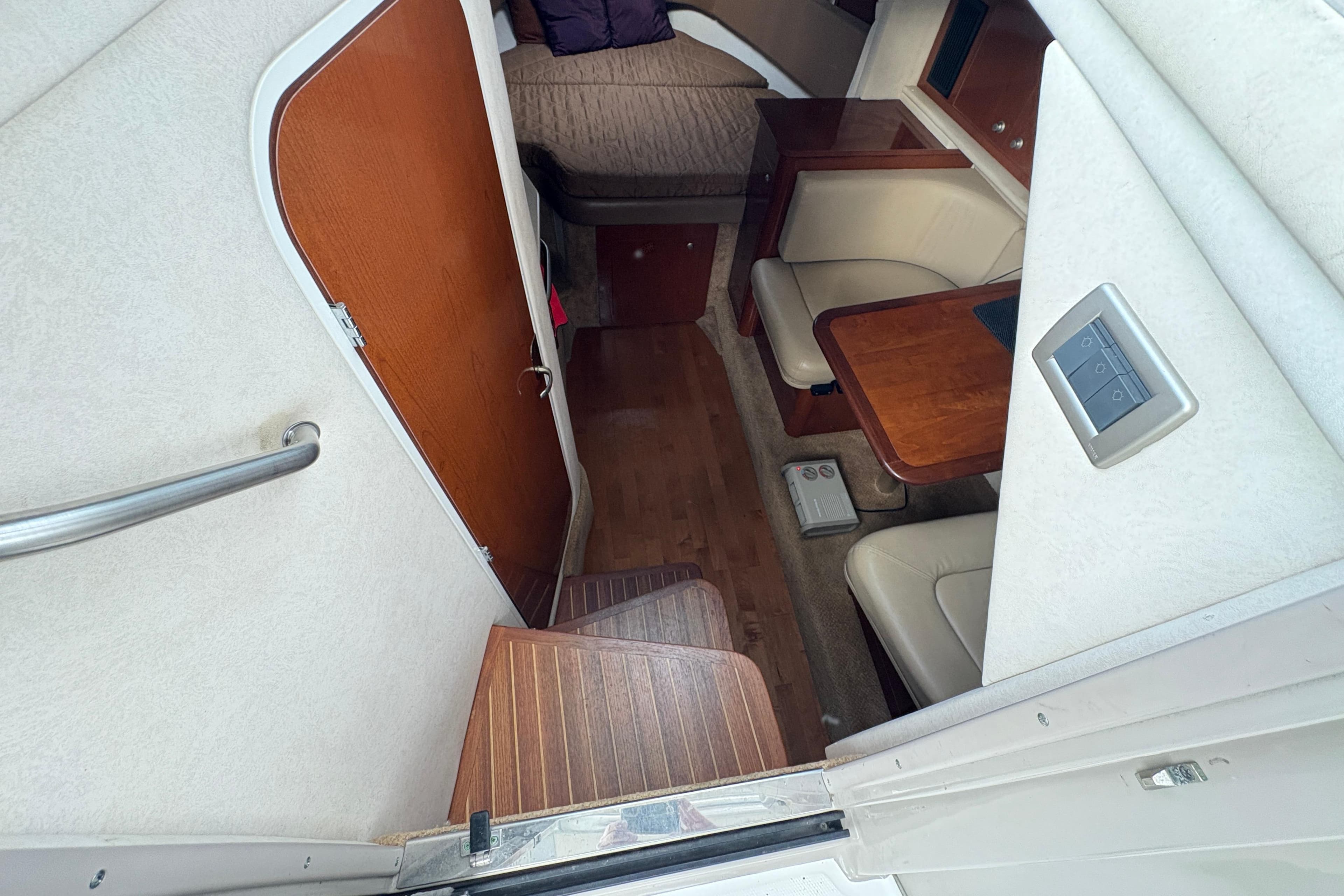 2009 Sea Ray 290 Amberjack cabin interior with seating and wooden table.