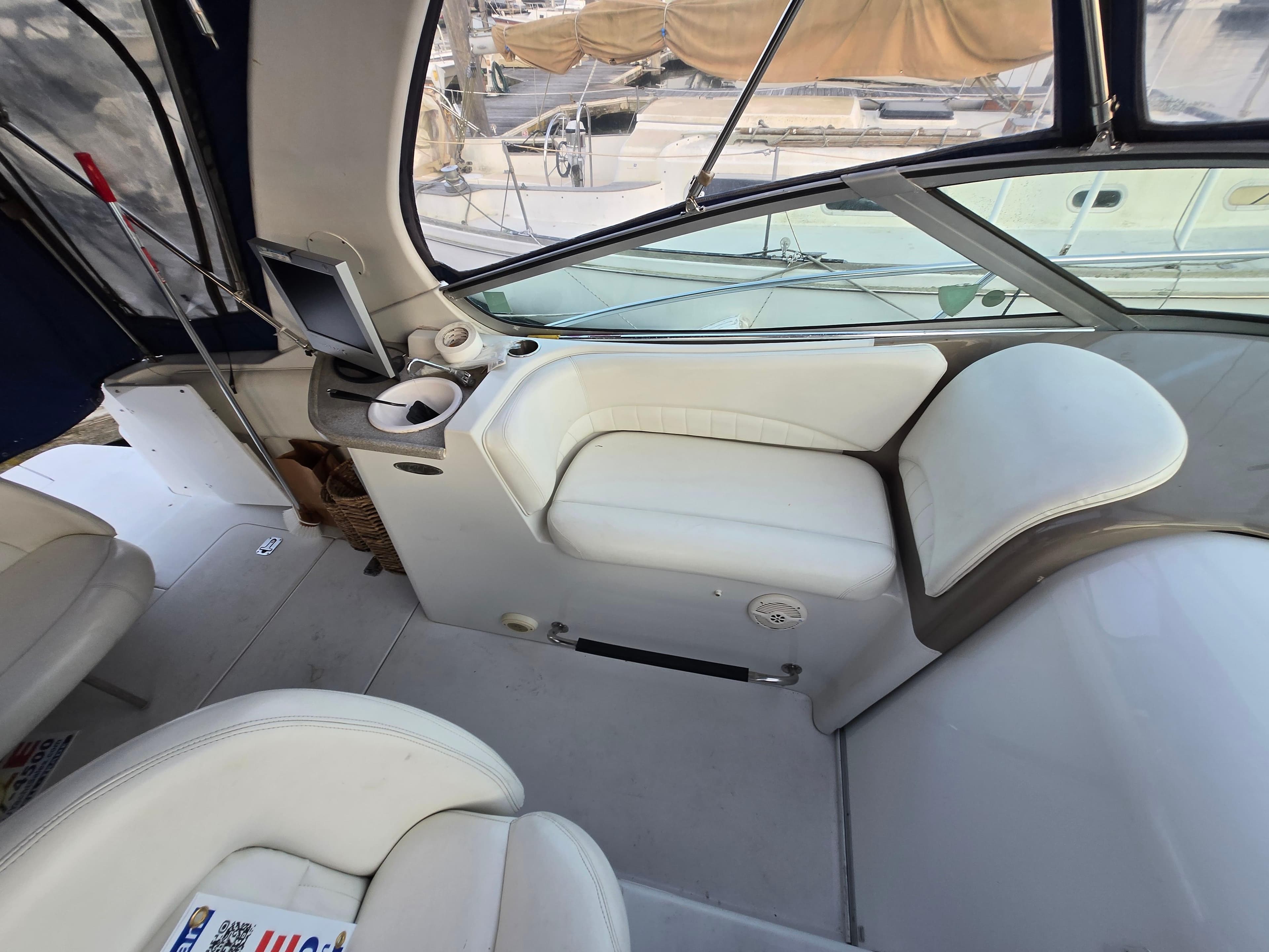 2003 Four Winns 328 Vista boat interior with white seating and control panel.