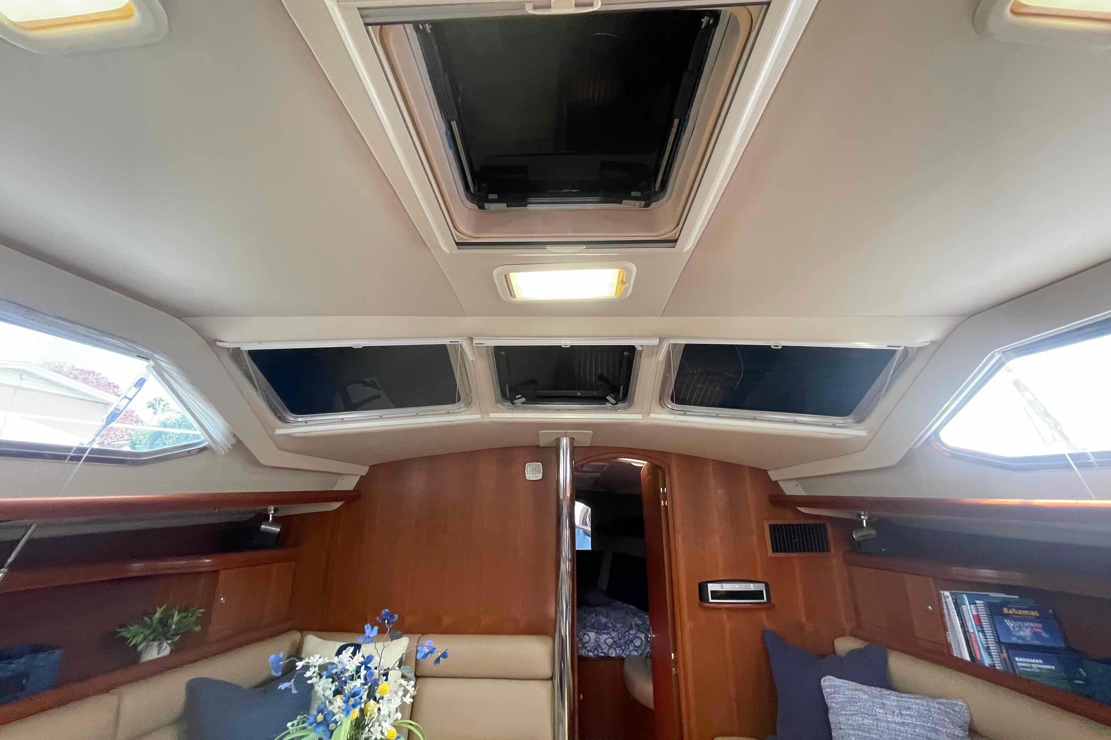 Interior of 2003 Hunter 426 Deck Salon with skylights and cozy seating area.  All new headliner.