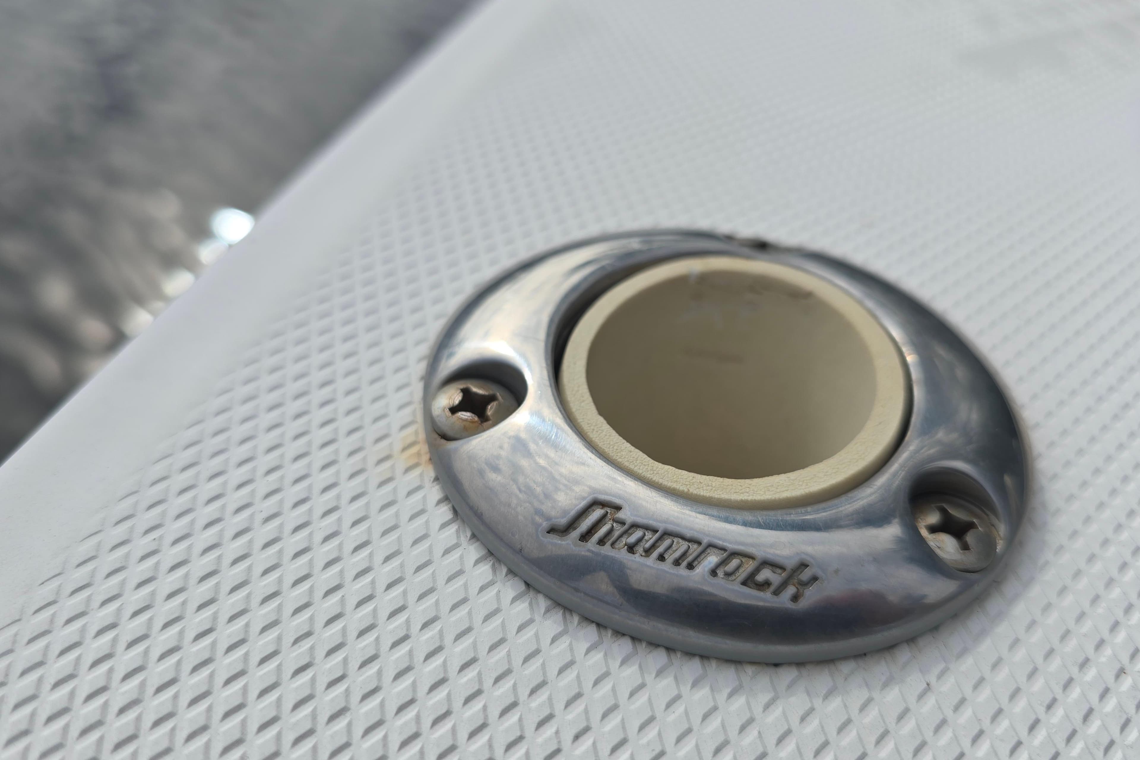 Close-up of a Shamrock 26 boat fitting, 2001 model, on textured surface.