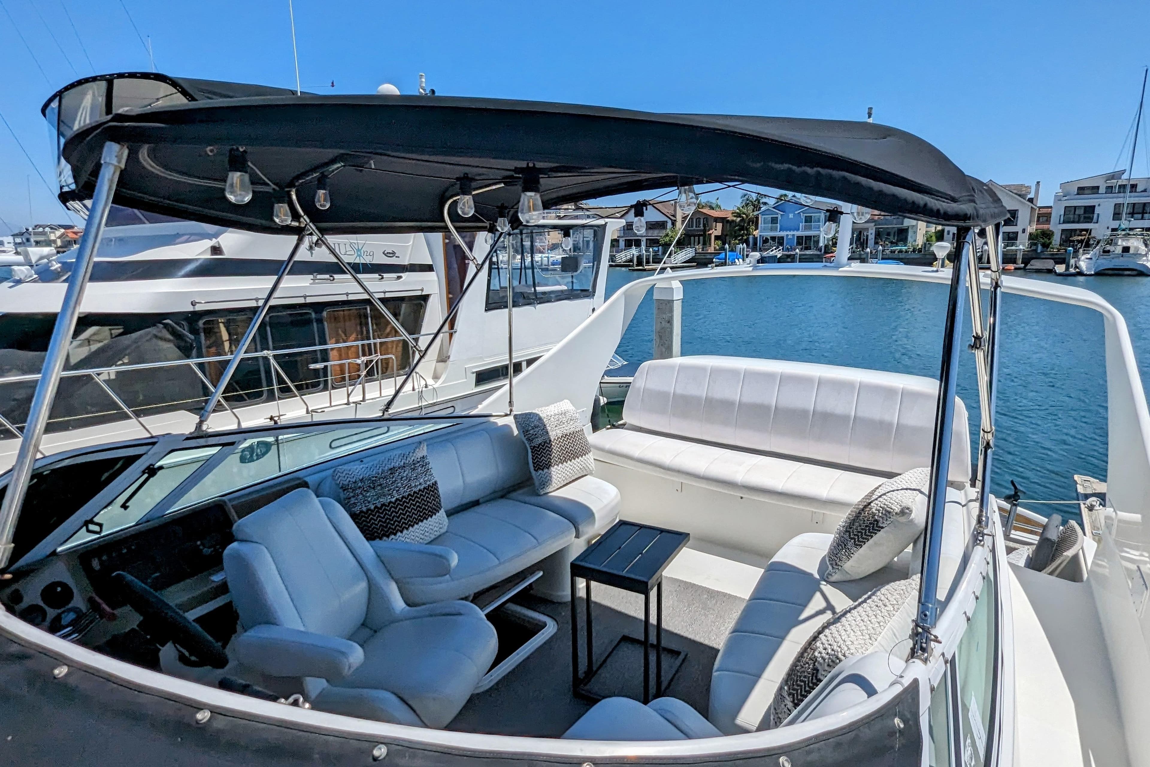 2004 Carver 360 Mariner yacht with spacious seating and canopy, docked in a marina.