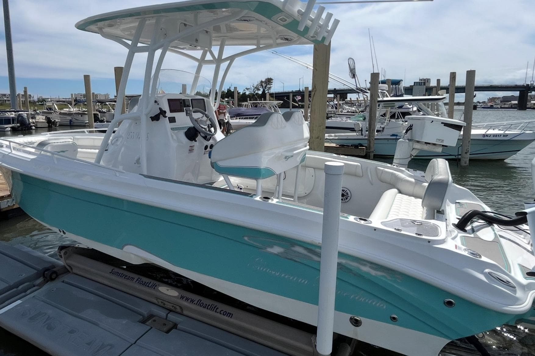 2021 Glasstream 255 Pro-XS boat docked at marina, featuring sleek design and turquoise accents.
