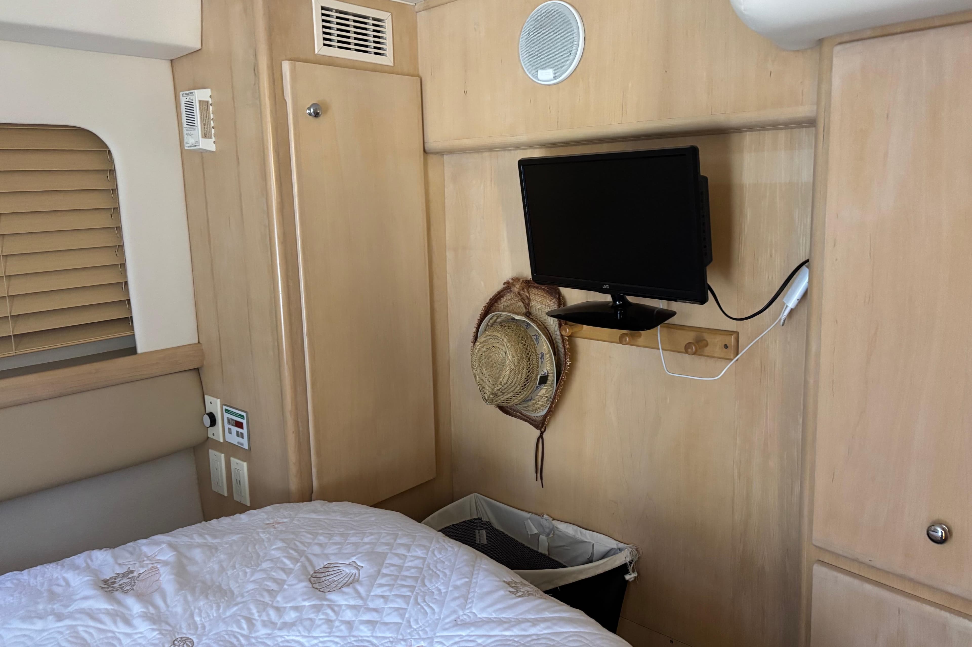 Interior of 1997 Carver 400 Cockpit Motor Yacht with TV and straw hat.