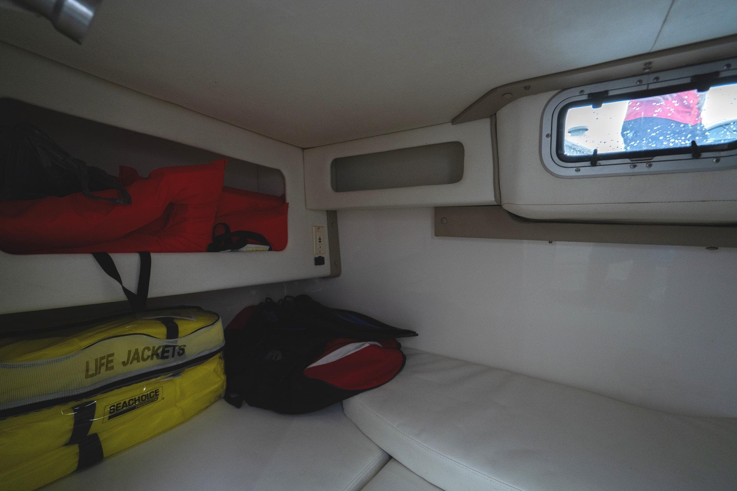Interior cabin of 2002 Century 3200 Walk-Around with life jackets and window.