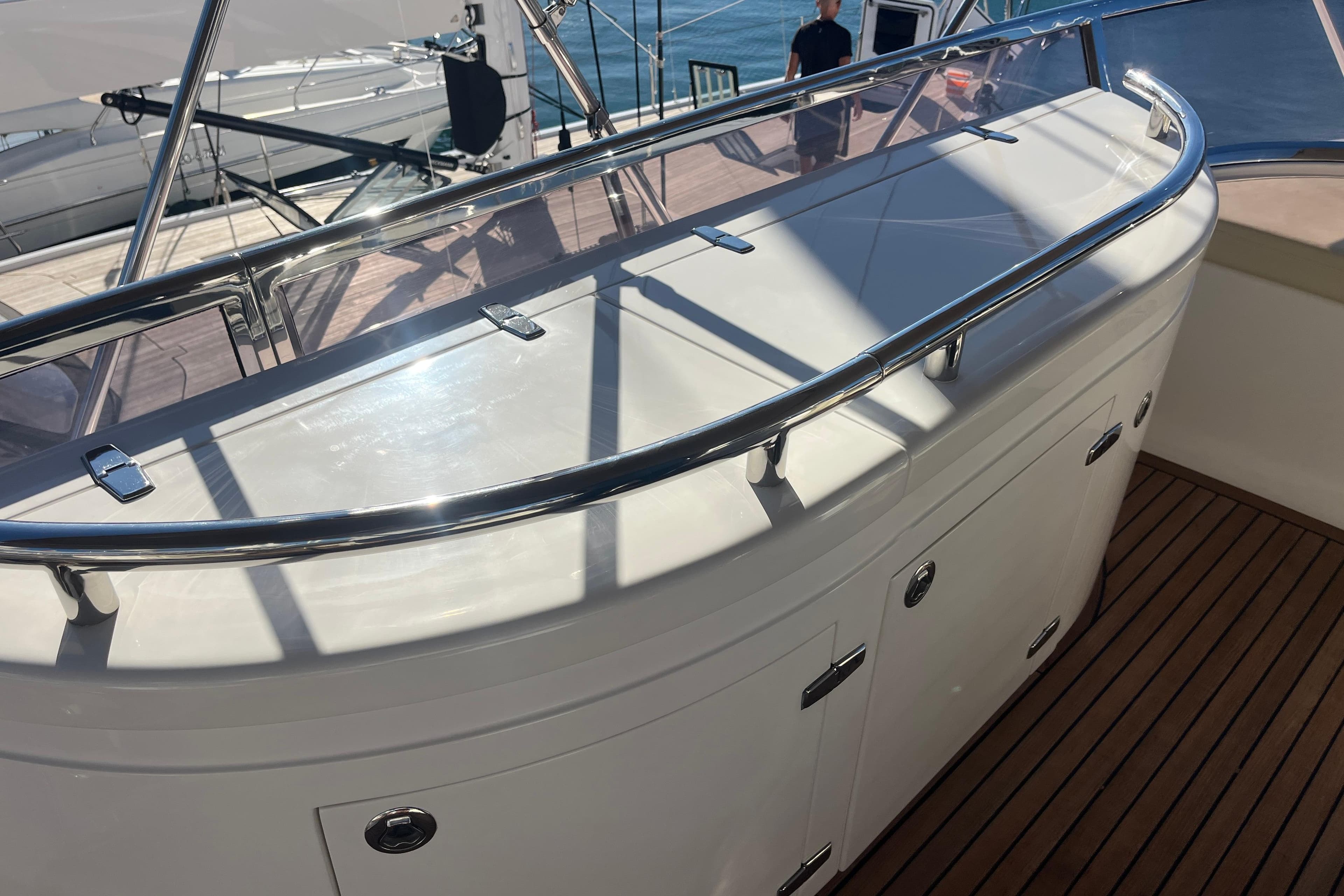 Luxury yacht deck with sleek railing and storage, Elegance 64 model, 2010.