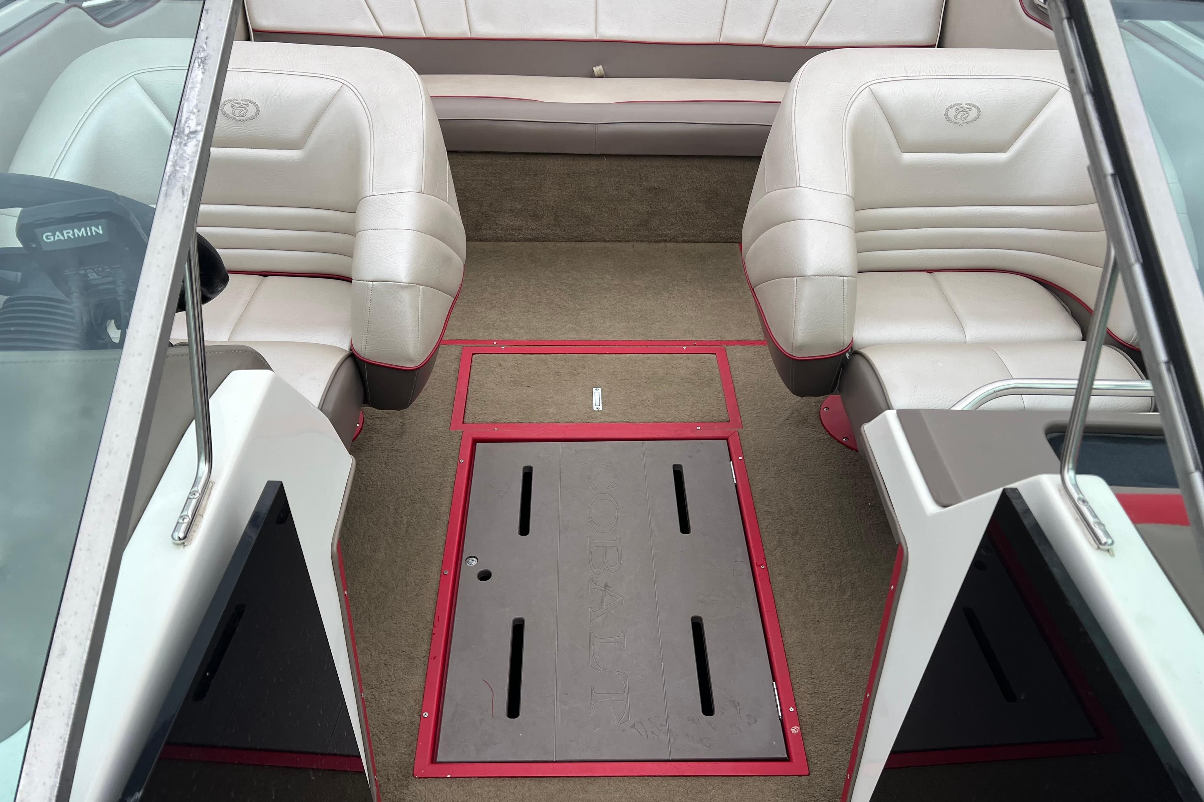 Interior of a 1996 Cobalt 220 boat with white seating and red accents.