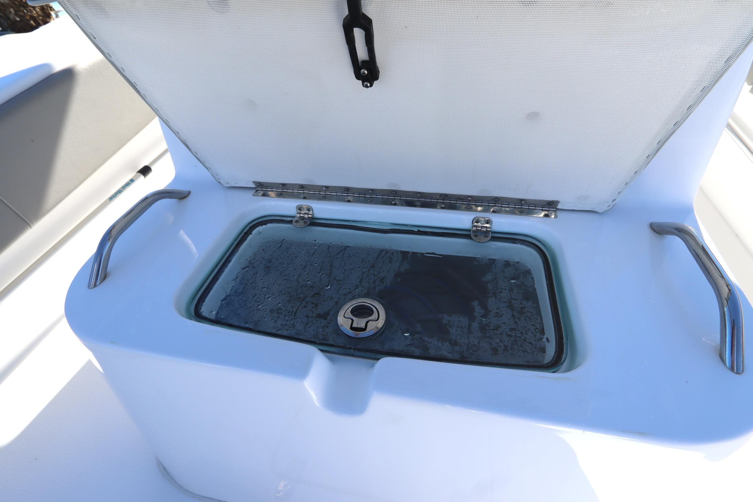 Open storage compartment on 2021 Cape Horn 31 T boat with stainless steel handles.
