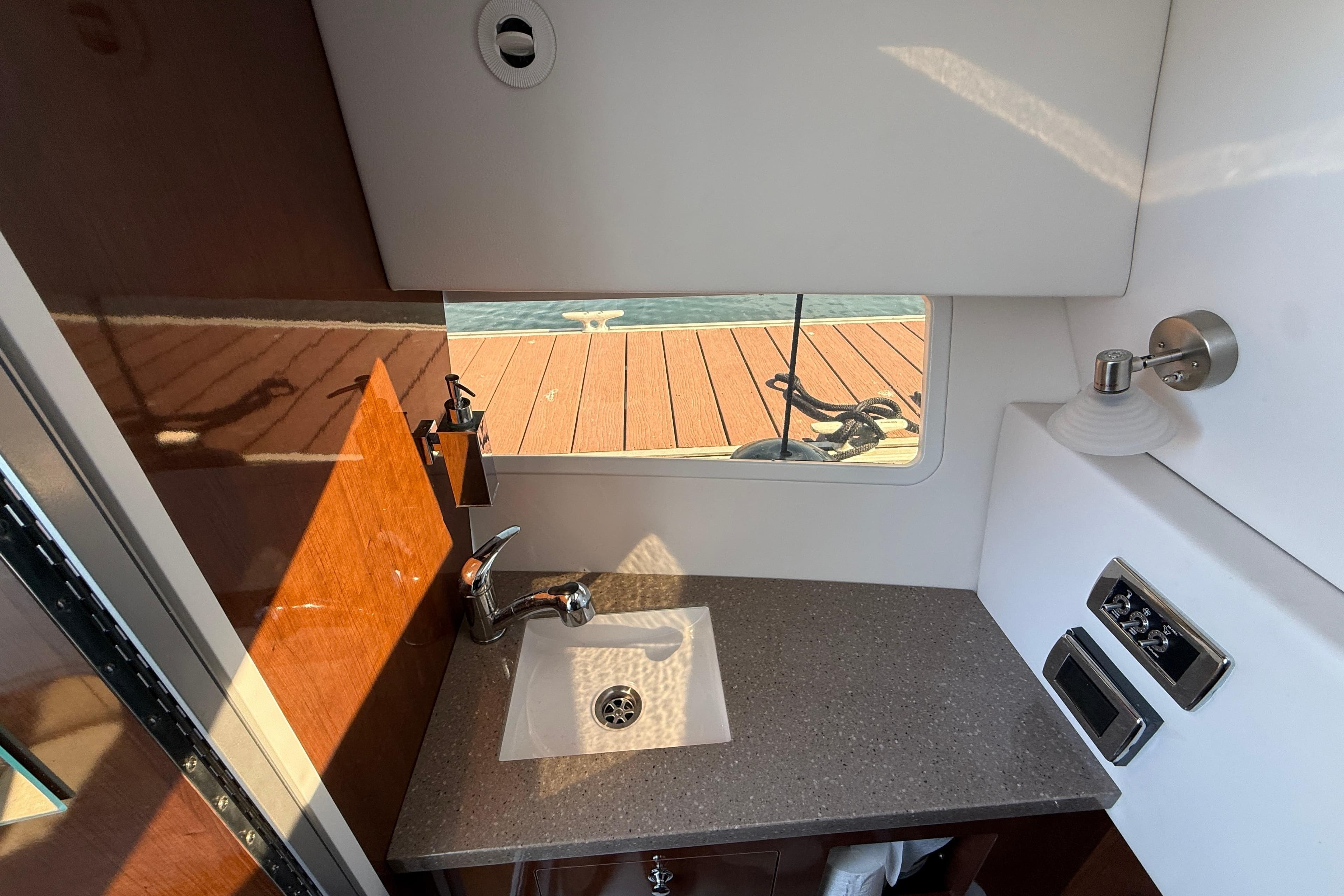 2018 Four Winns H350 boat interior with sink, countertop, and window view.