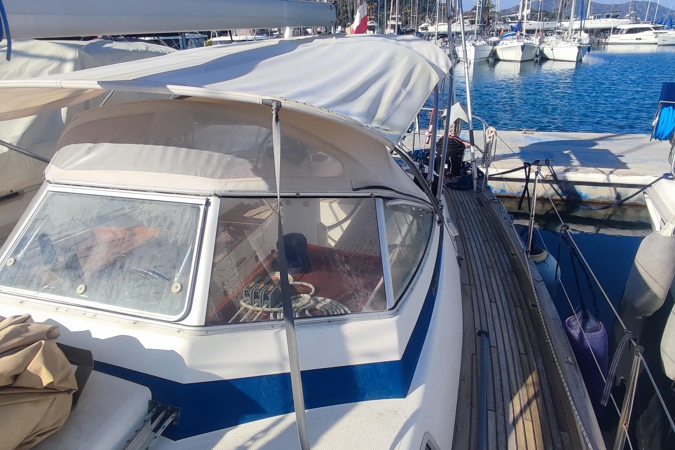 Sailboat Hallberg-Rassy 36 MKII, 2002 model, docked at marina with clear blue water.