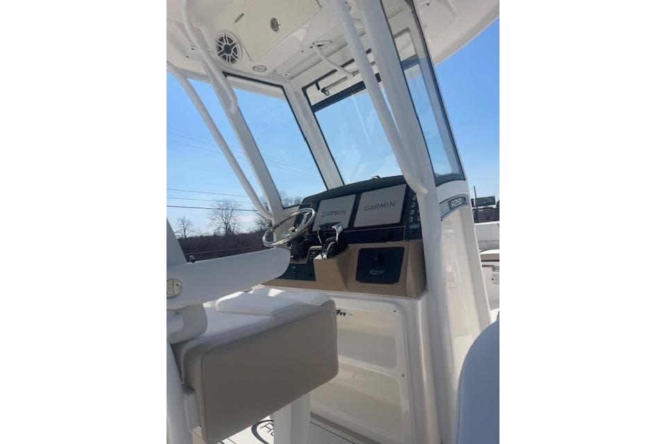 2026 Robalo R250 Center Console boat interior with Garmin displays and steering wheel.