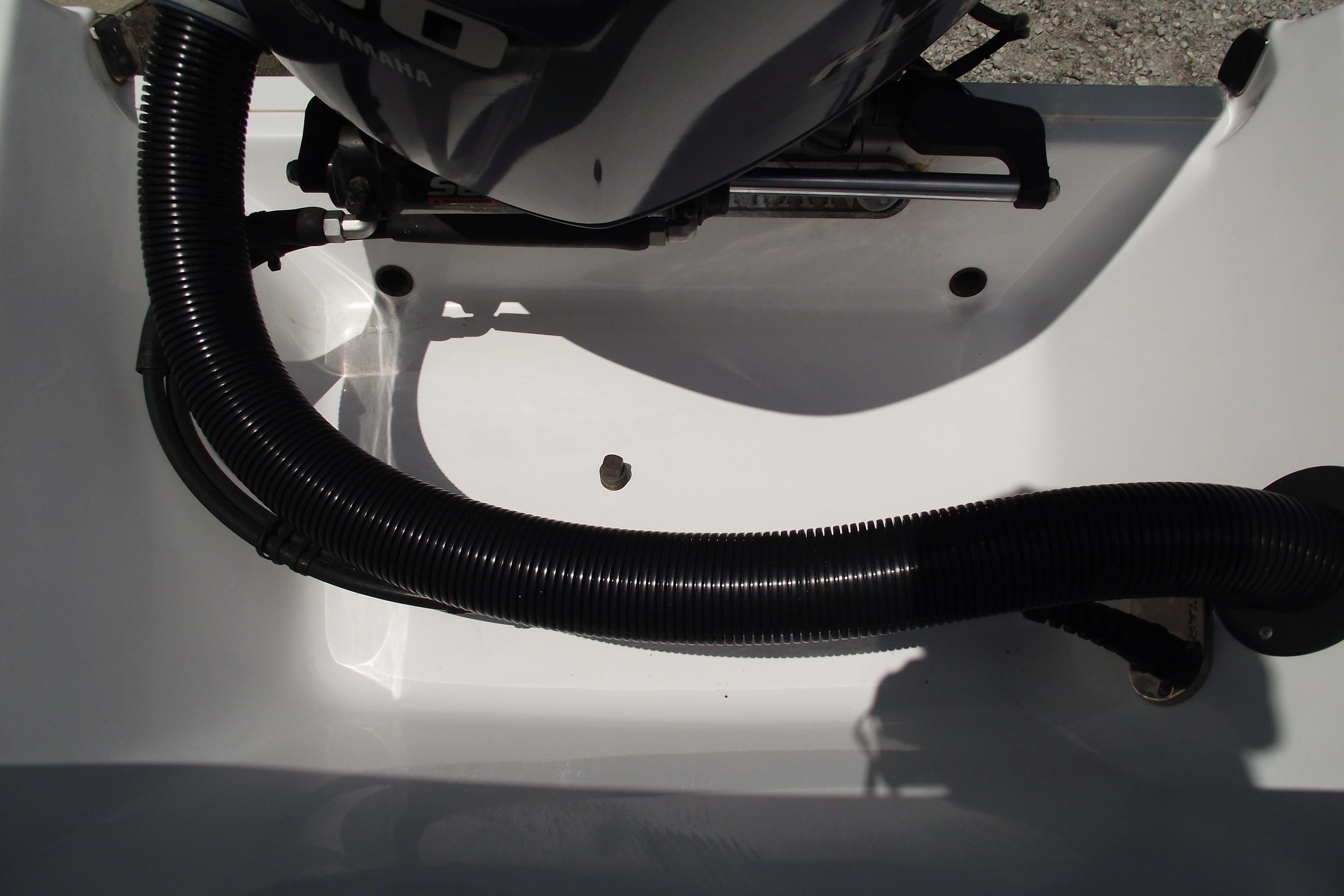 2020 Sportsman Open 212 Center Console boat engine compartment with black hose.