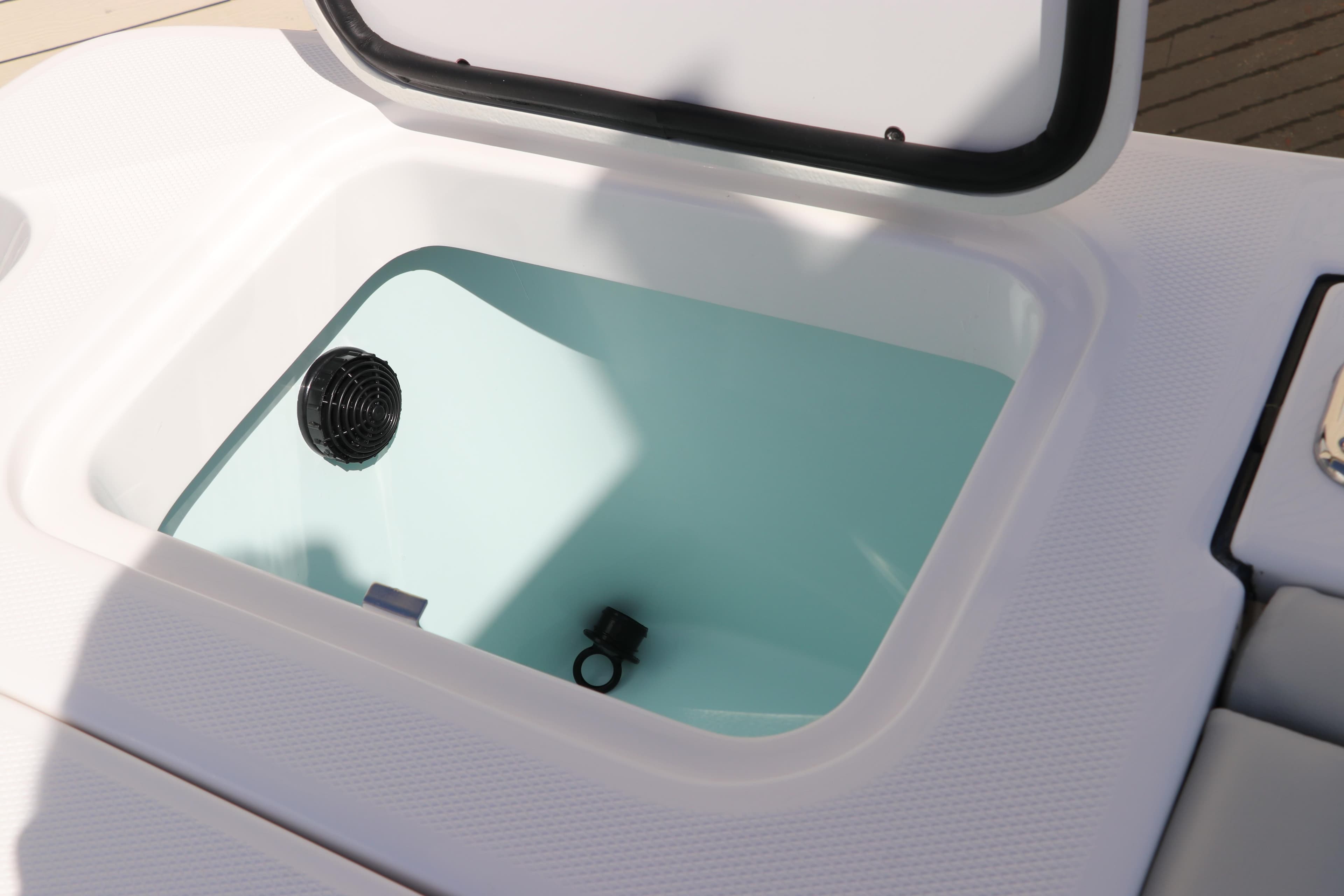 Open storage compartment on 2025 Edgewater 325CC boat.