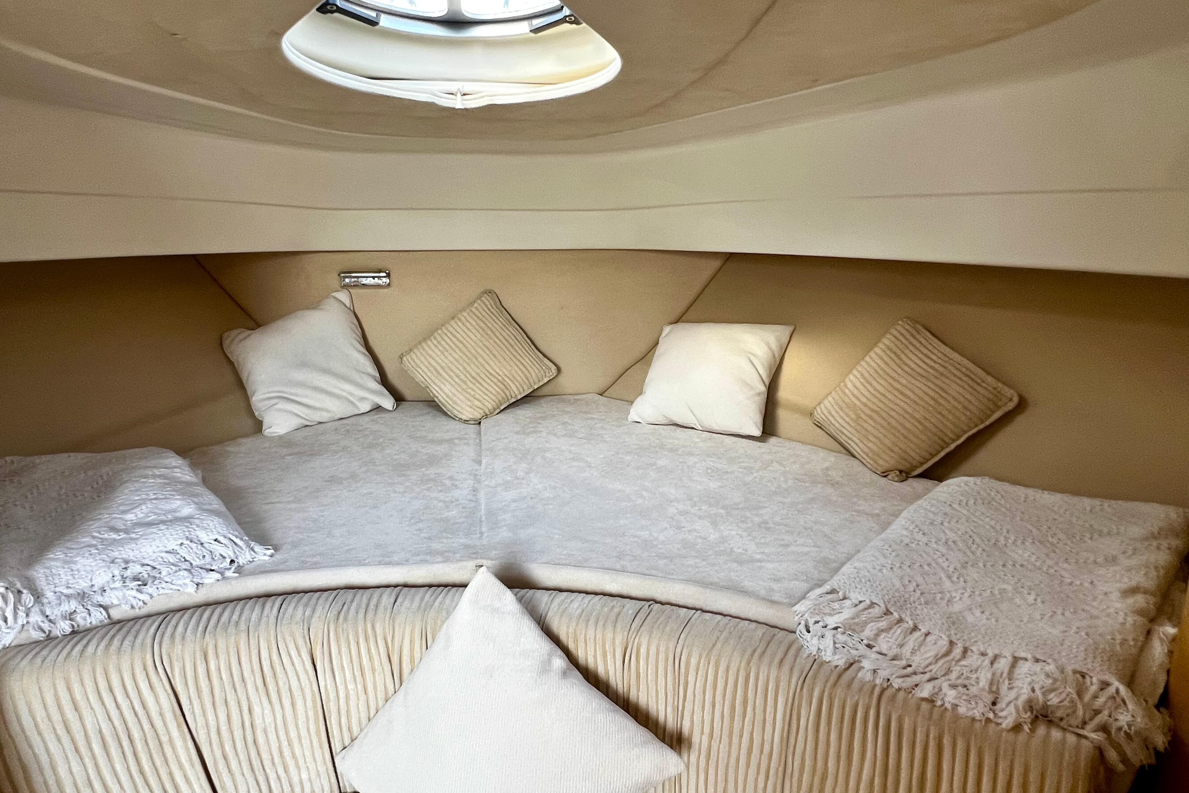 Luxurious interior cabin of 2007 Cranchi Zaffiro 32 yacht with cozy bedding.