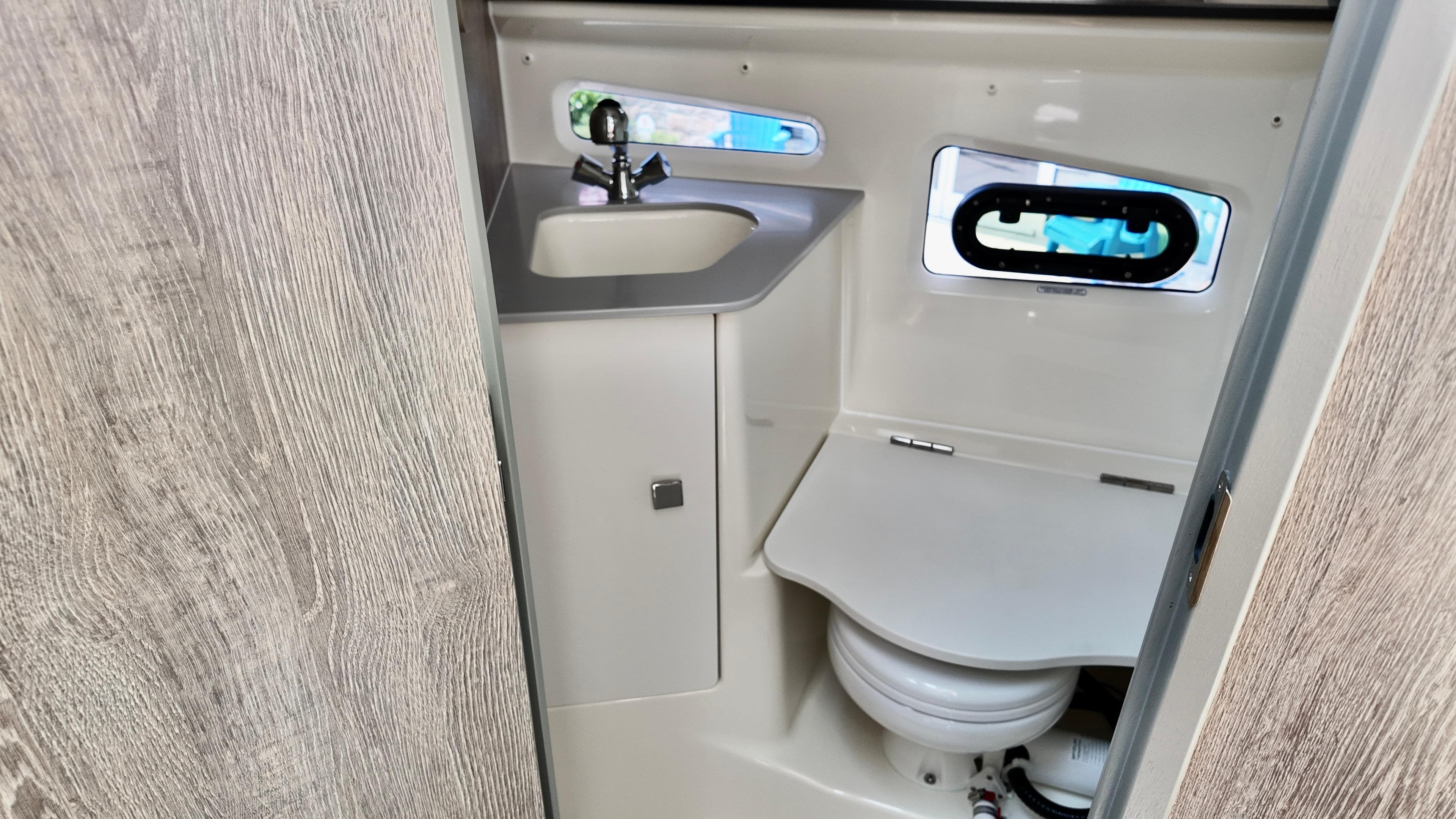 2025 Bayliner Trophy 29 Explorer bathroom with sink and toilet, featuring modern design.