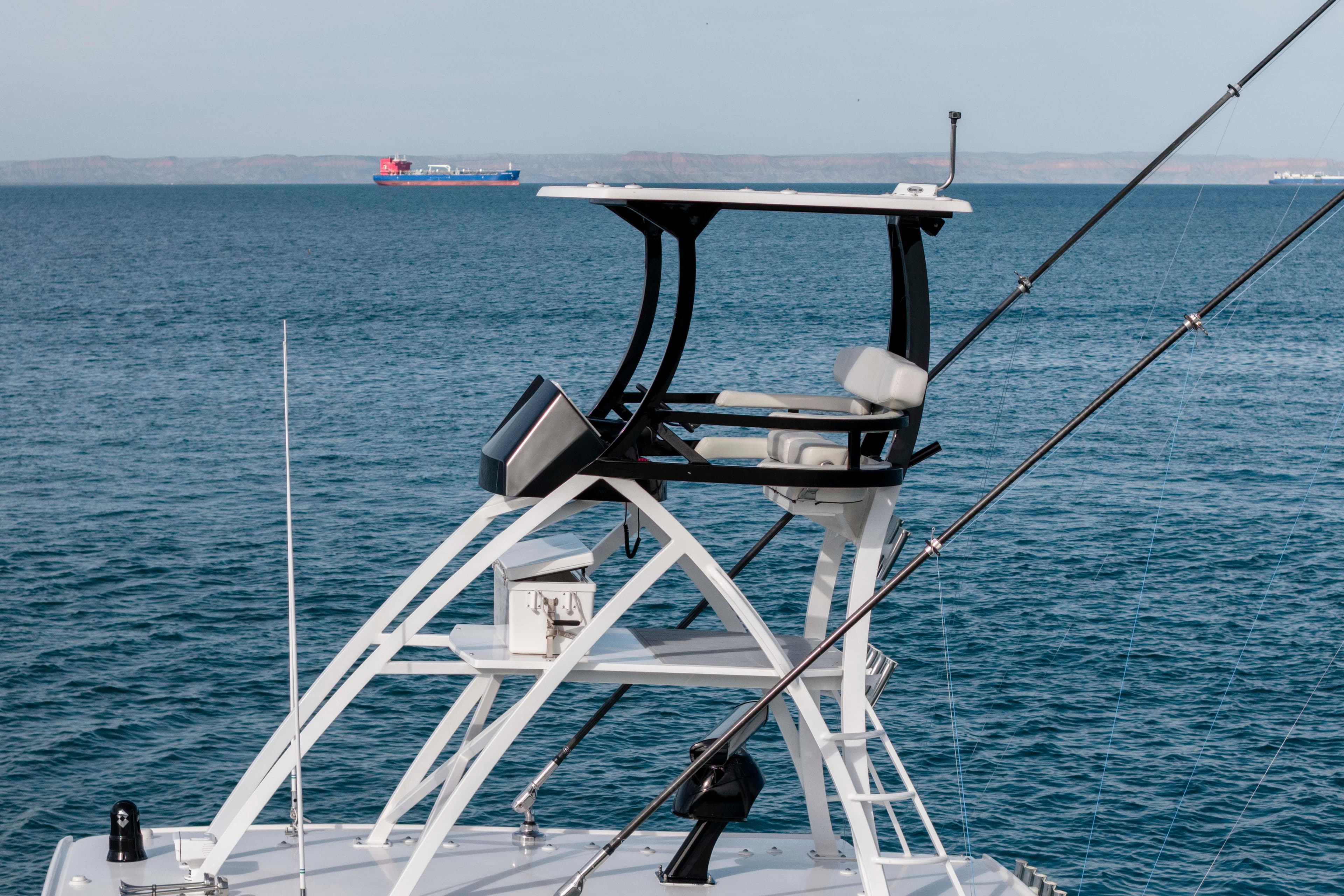 2022 HCB 53 Suenos RXV yacht with elevated helm, ocean backdrop.