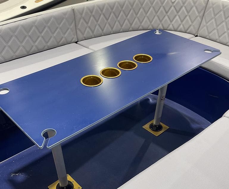 2023 Vision Marine Technologies Volt 180 boat interior with blue table and cup holders.
