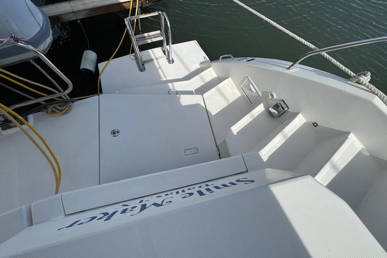 Stern view of a 2017 Leopard 45 catamaran docked, featuring steps and railing.