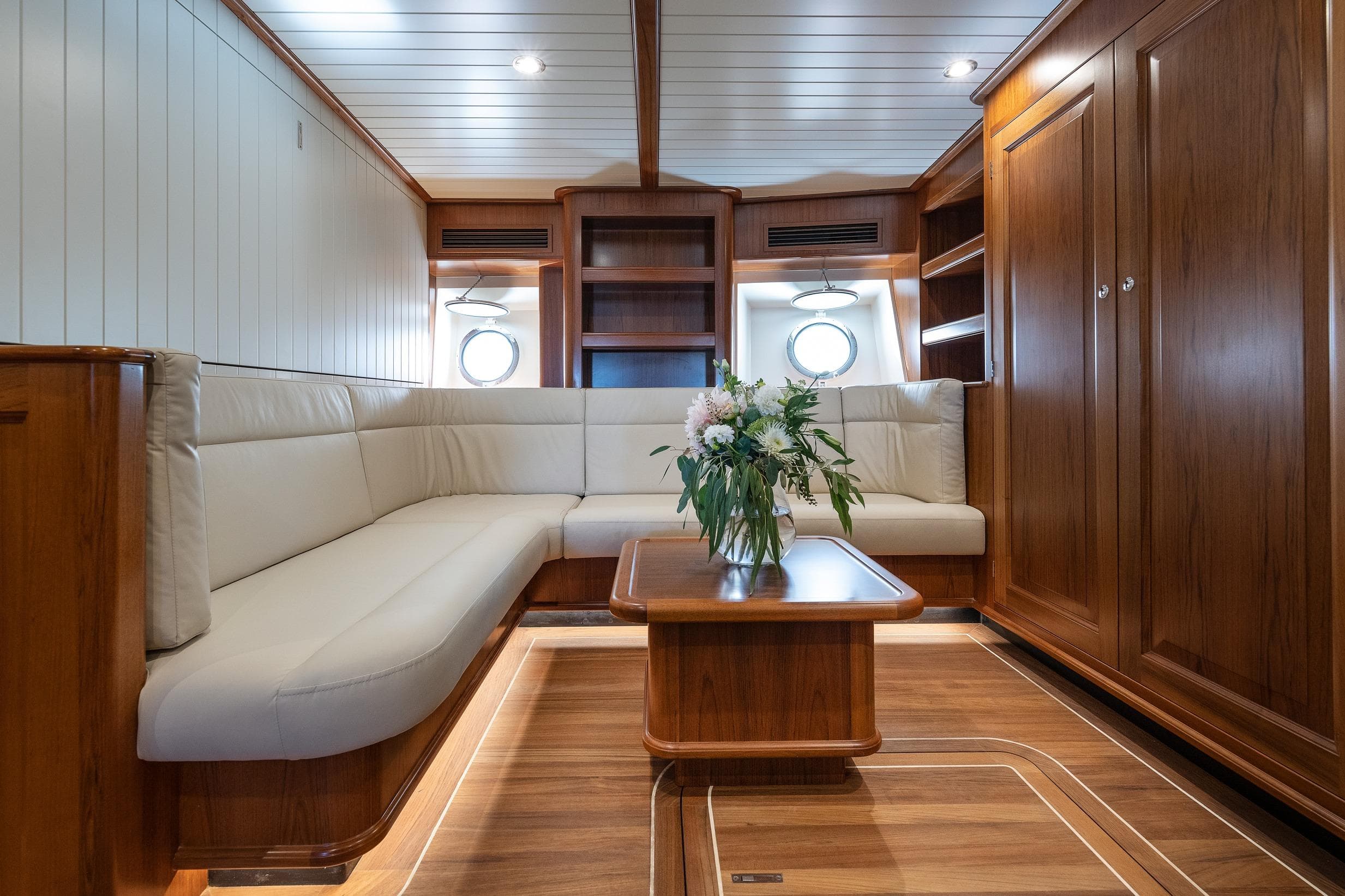 Luxurious 2022 Ridas Custom Yacht interior with elegant wood finish and plush seating.