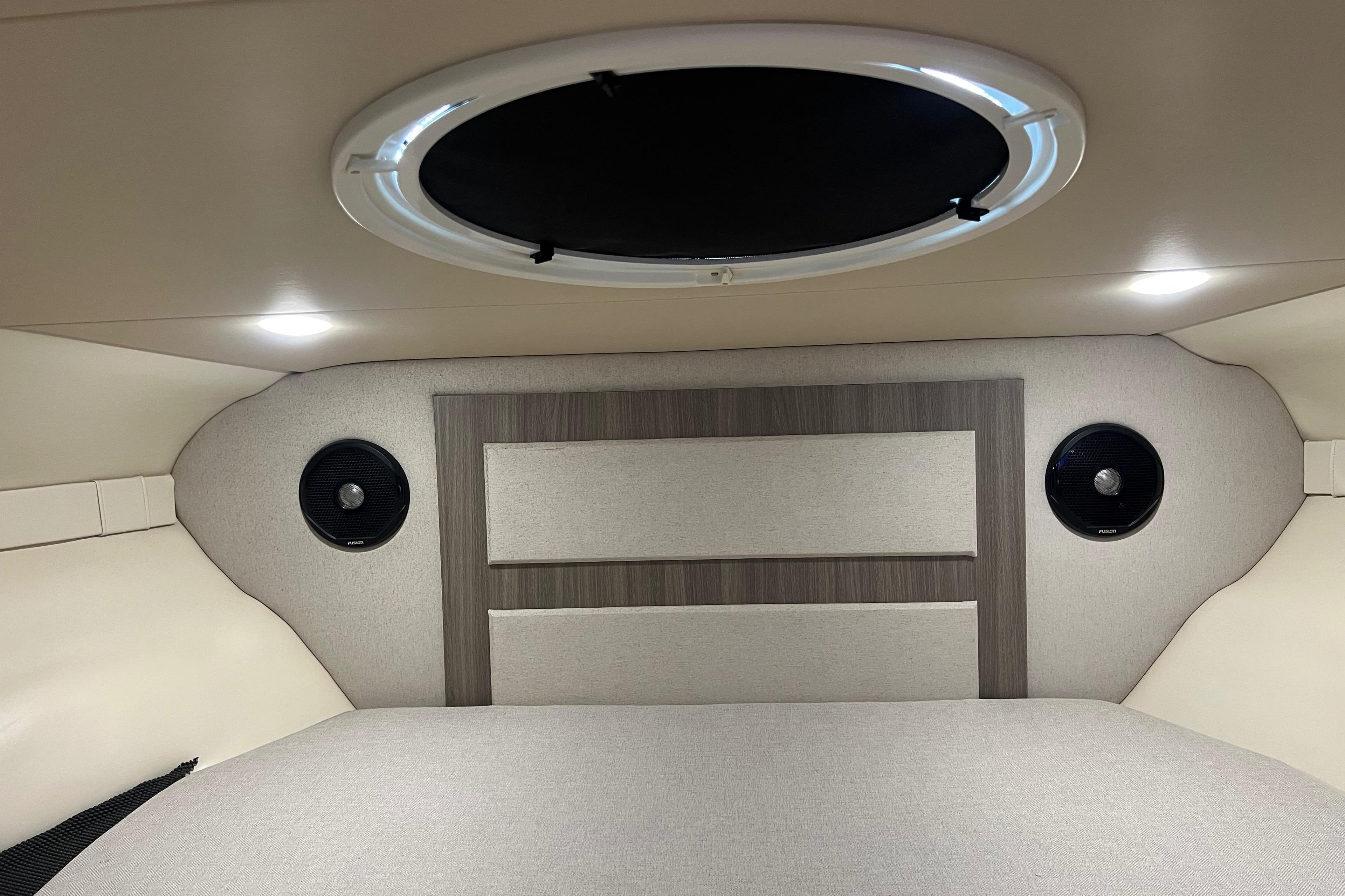 2019 Regal 33 Express cabin interior with circular window and modern design elements.