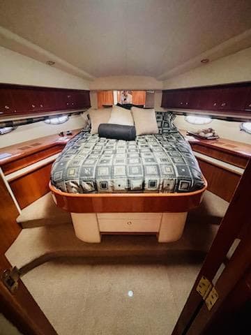 Luxurious cabin interior of 2006 Neptunus 55 Cabrio yacht with elegant bedding.