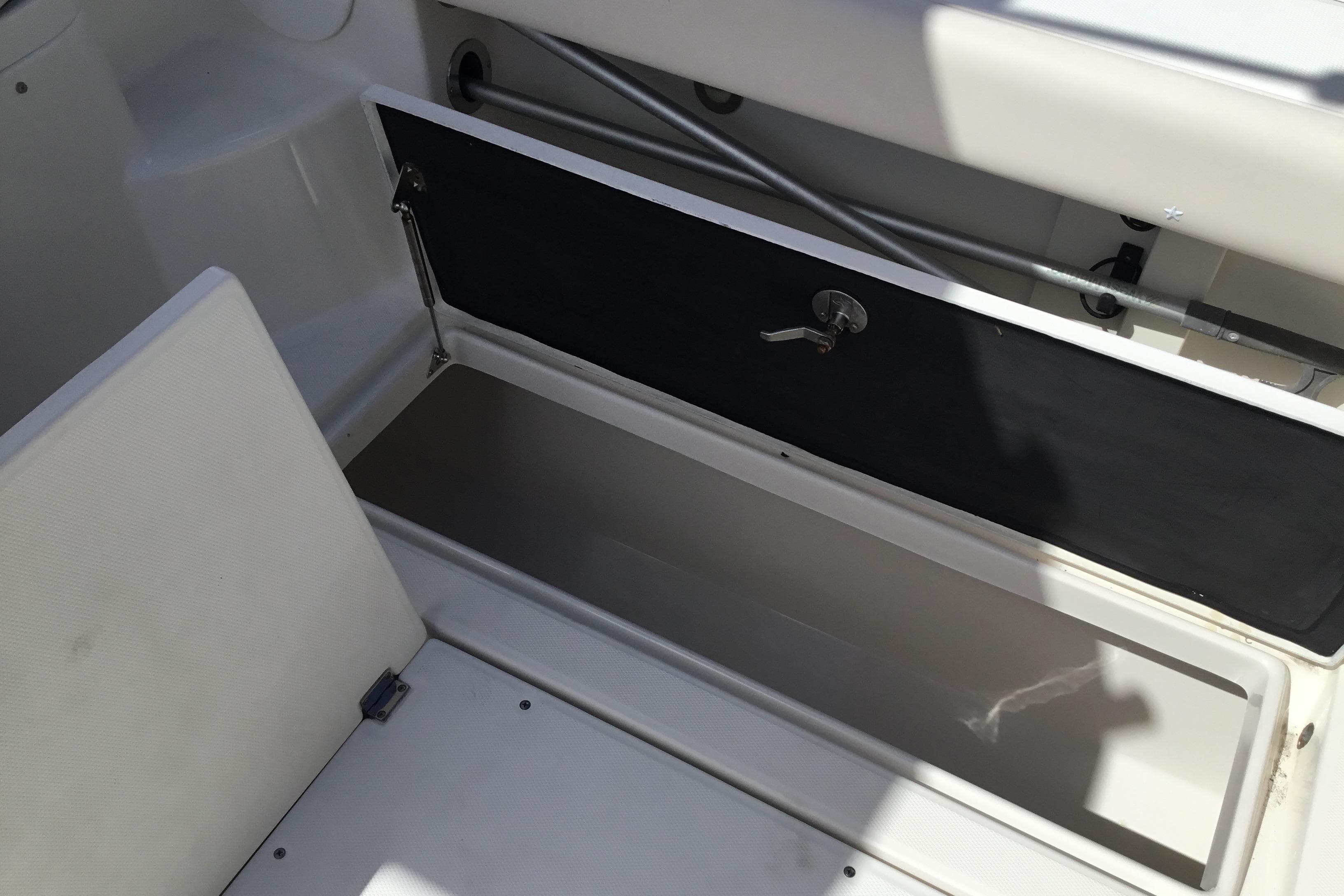 2017 Robalo R305 Walkaround boat storage compartment with open hatch and latch.
