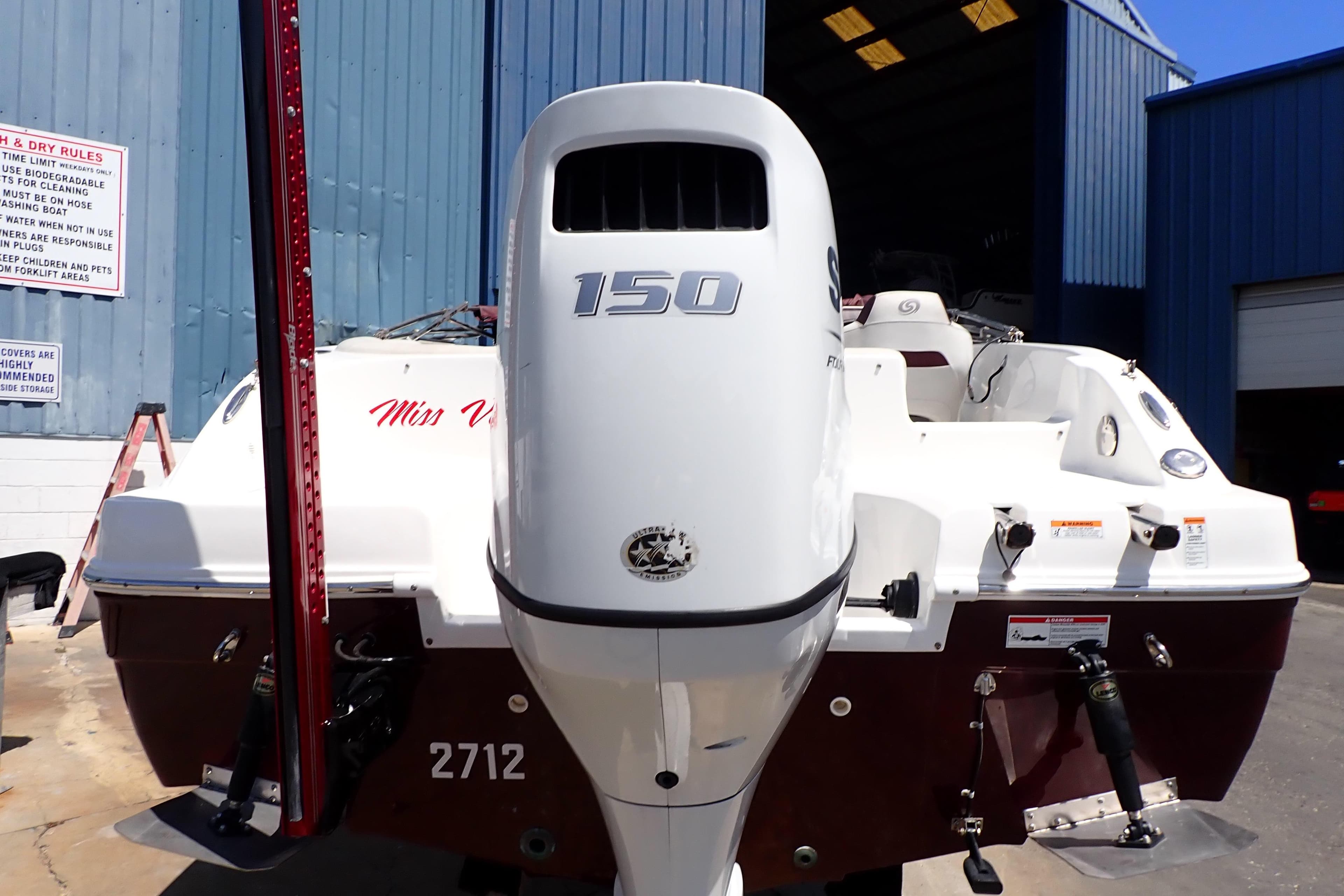 2021 Hurricane SunDeck Sport 185 OB boat with 150 HP engine at a marina.