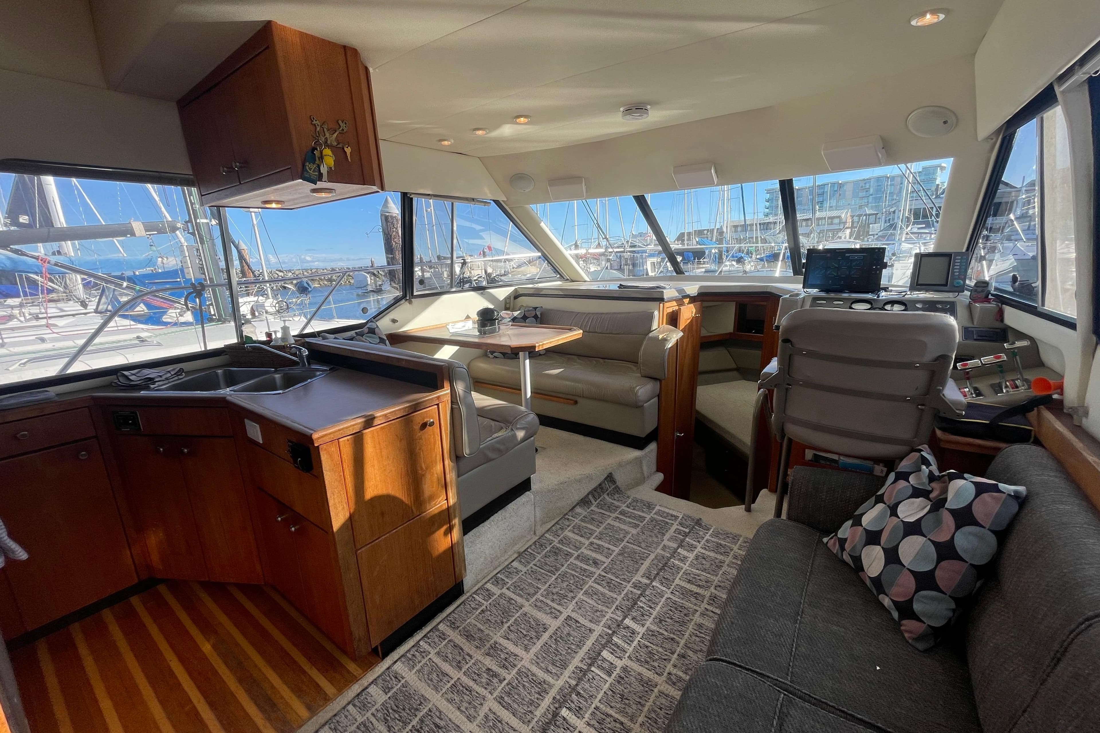 1996 Bayliner 4087 Aft Cabin Motoryacht interior with kitchen, seating, and helm station.