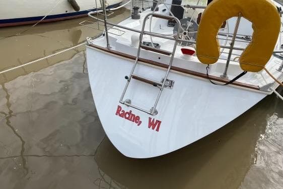 1993 Catalina 34 MkII sailboat docked, featuring Racine, WI lettering and a yellow life ring.