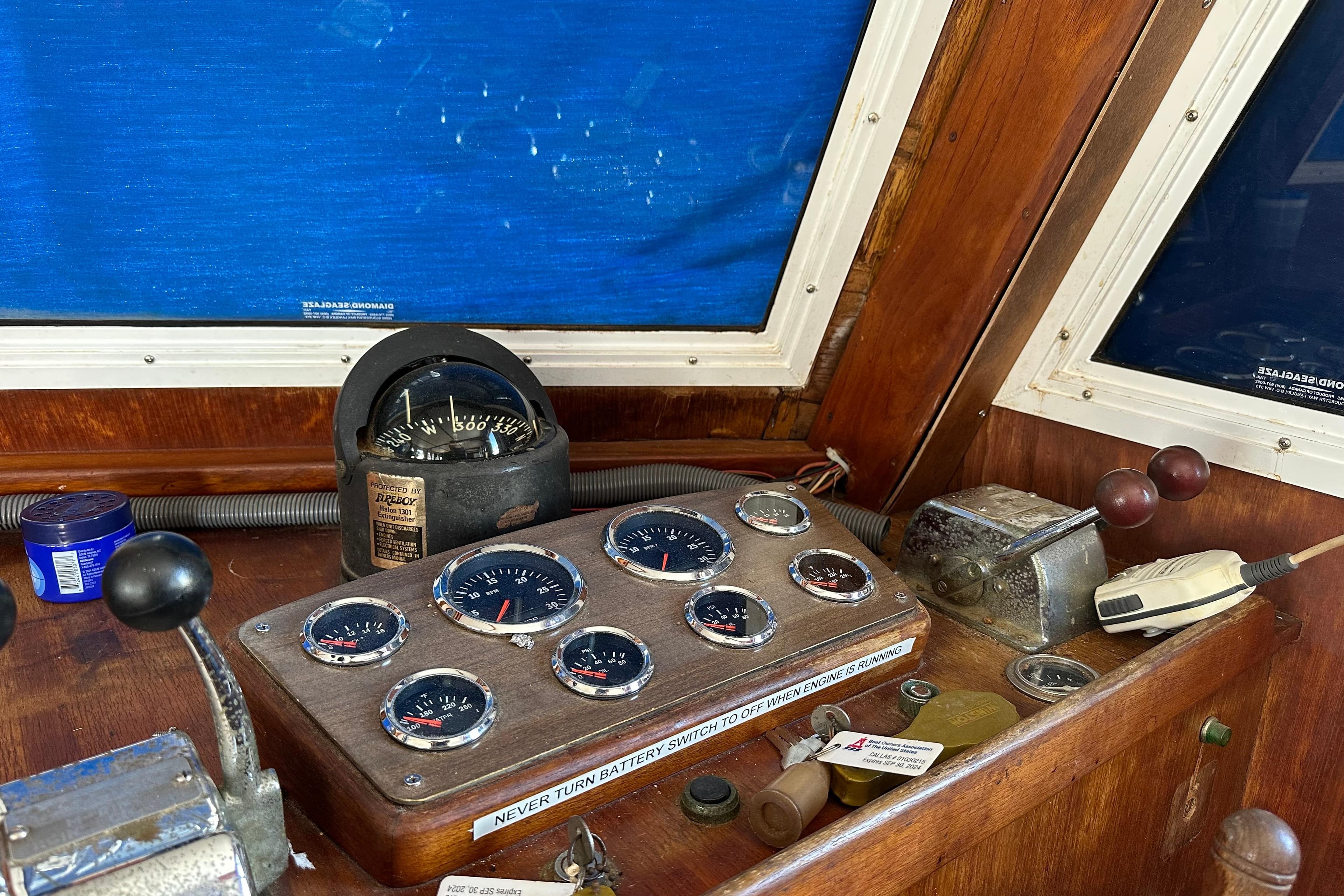 1979 Marine Trader 38DC dashboard with gauges and controls in a wooden cabin.