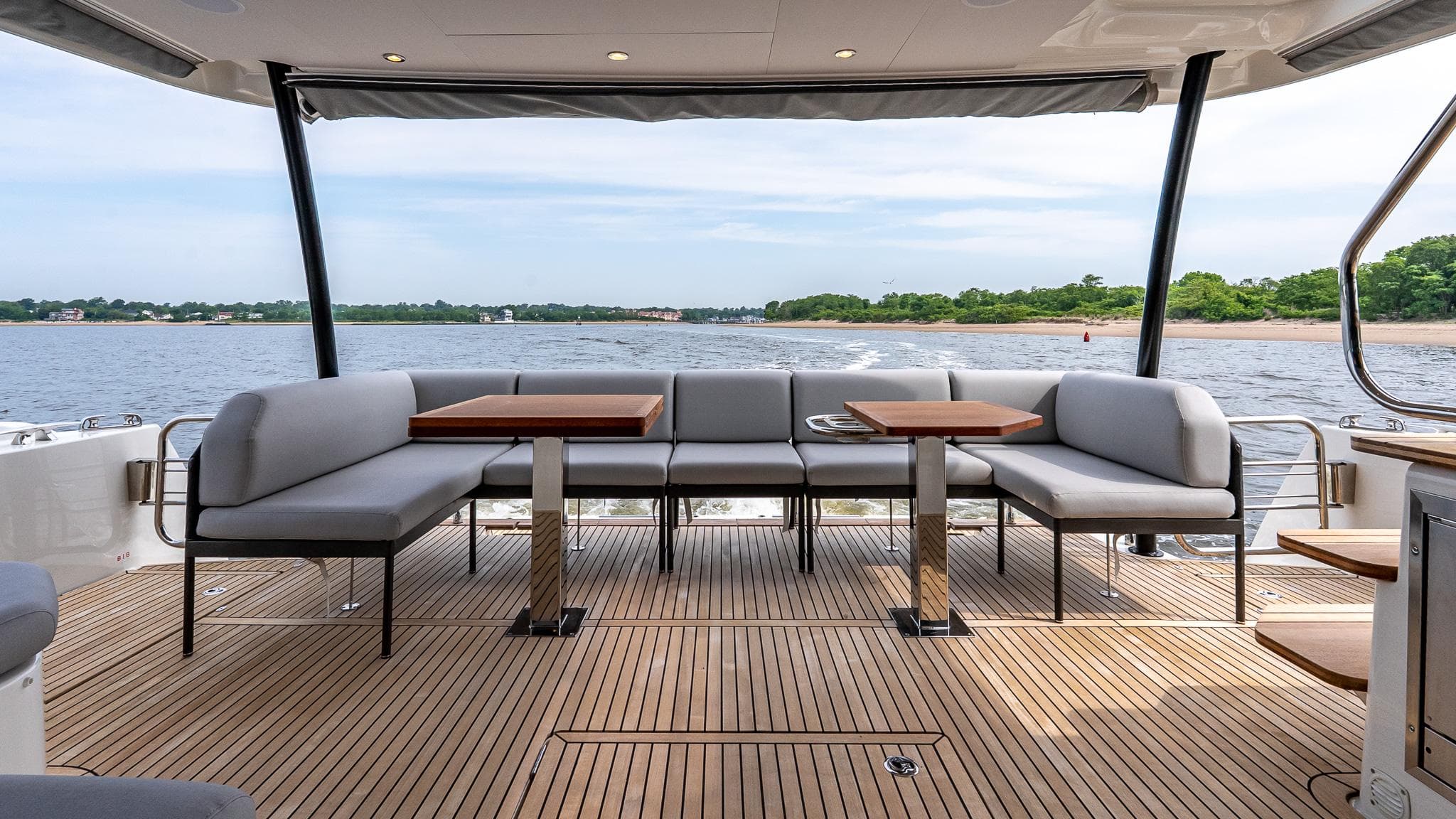 Luxurious 2026 Prestige M48 yacht deck with elegant seating and scenic water view.
