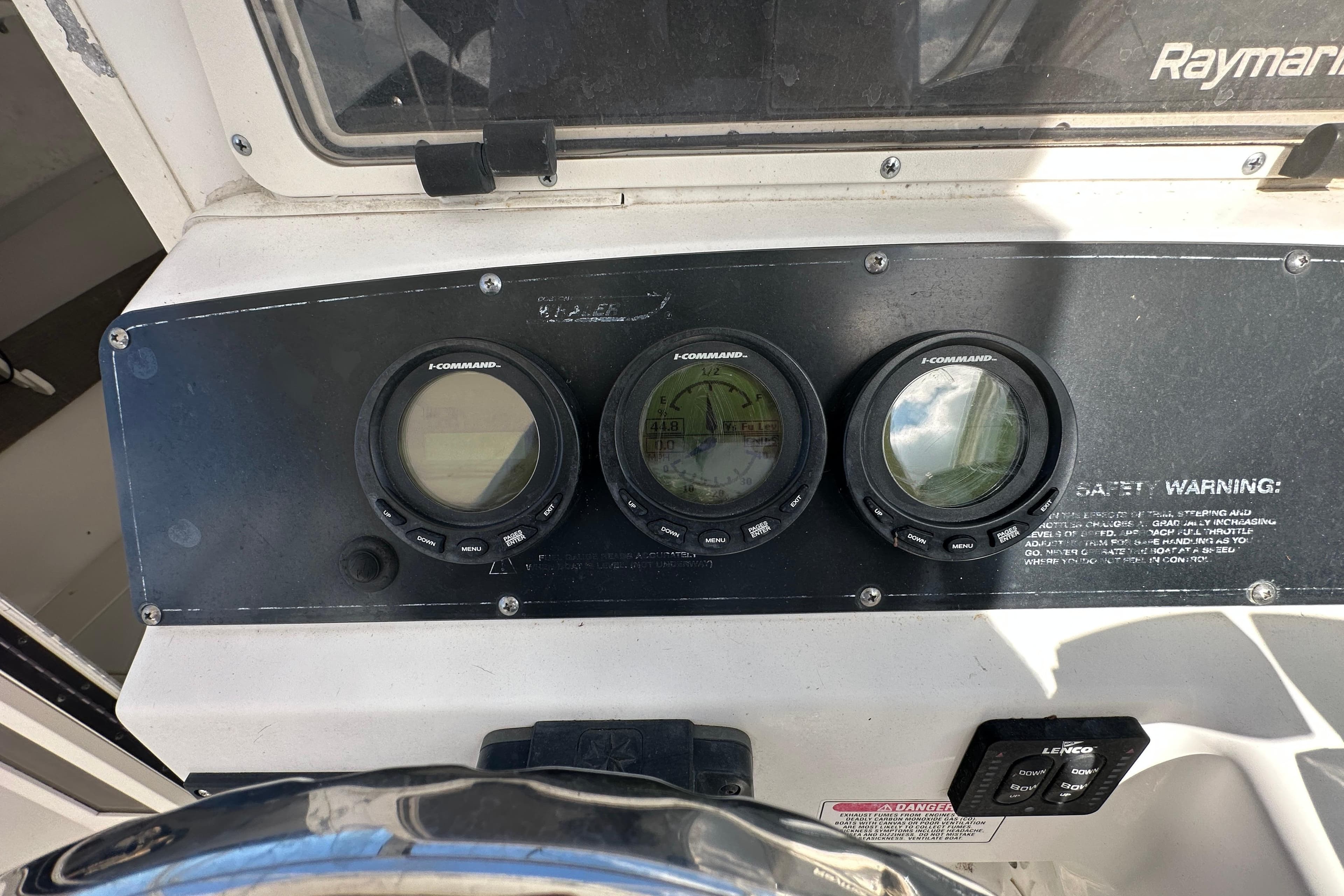 Dashboard of a 2001 Boston Whaler 23 Conquest boat with I-Command gauges.